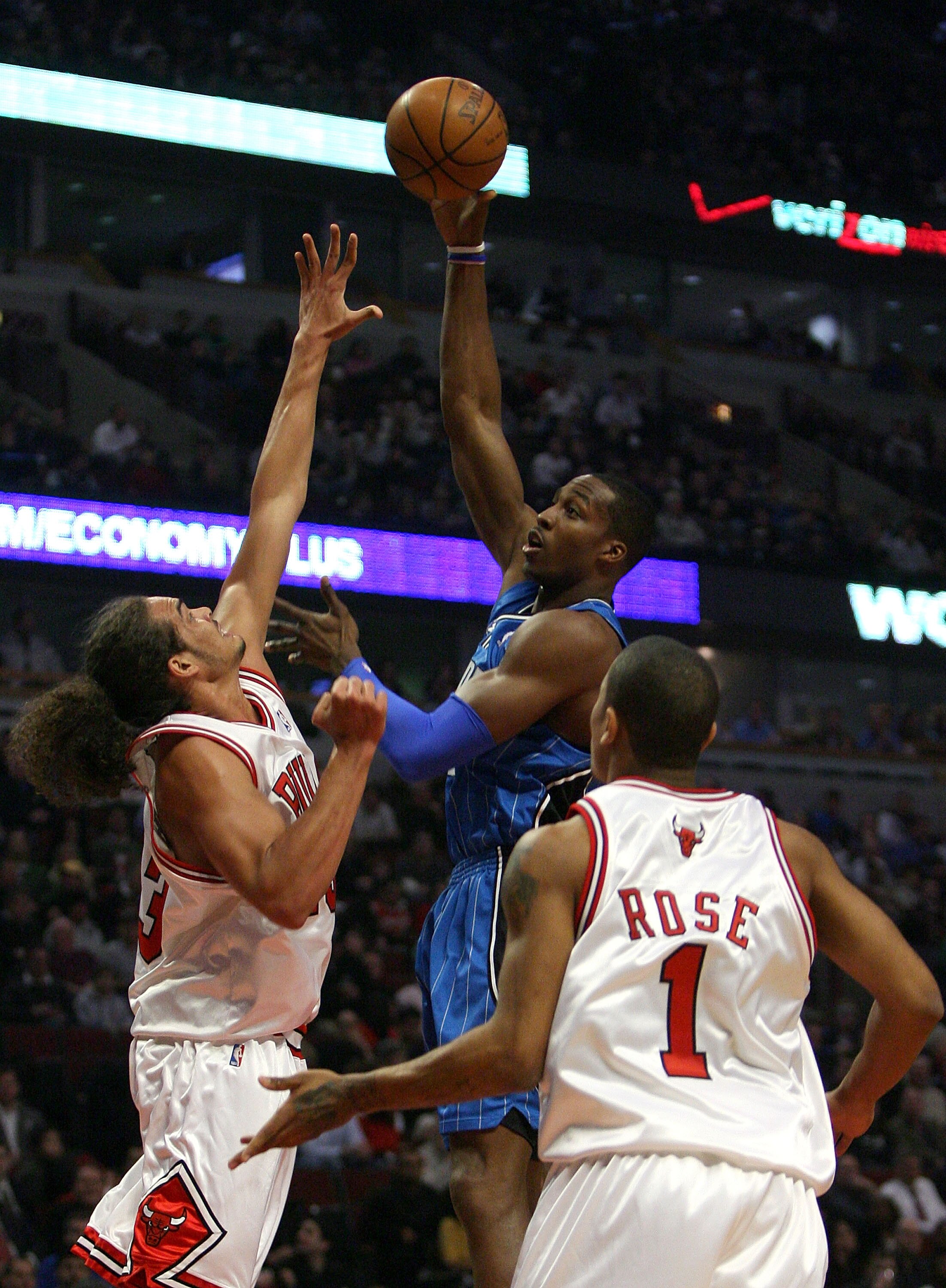 CHICAGO - FEBRUARY 24:  Dwight Howard #12 of the Orlando Magic attempts a shot aganst Joakim Noah #13 and Derrick Rose #1 of the Chicago Bulls at the United Center on Feberuary 24, 2009 in Chicago, Illinois.  NOTE TO USER: User expressly acknowledges and