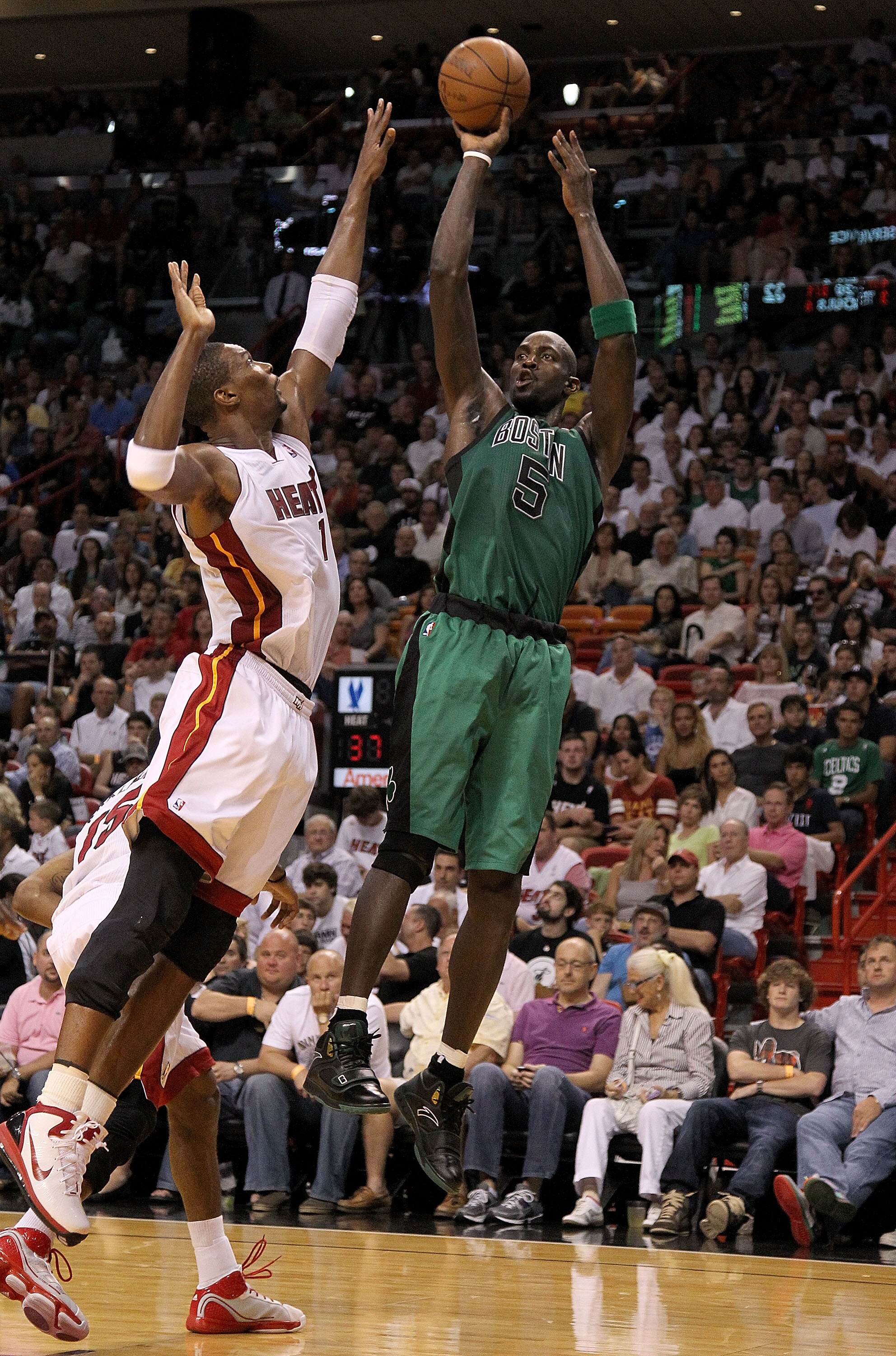 MIAMI, FL - APRIL 10:  Kevin Garnett #5 of the Boston Celtics shoots over Chris Bosh #1 of the Miami Heat during a game at American Airlines Arena on April 10, 2011 in Miami, Florida. NOTE TO USER: User expressly acknowledges and agrees that, by downloadi