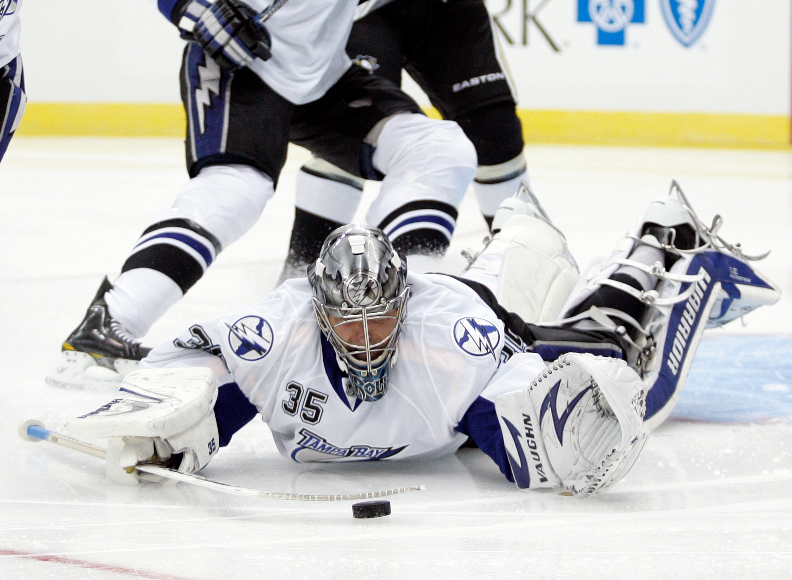 PITTSBURGH, PA - APRIL 13: Dwayne Roloson #35 of the Tampa Bay Lightning makes a save against the Pittsburgh Penguins in Game One of the Eastern Conference Quarterfinals during the 2011 NHL Stanley Cup Playoffs at Consol Energy Center on April 13, 2011 in