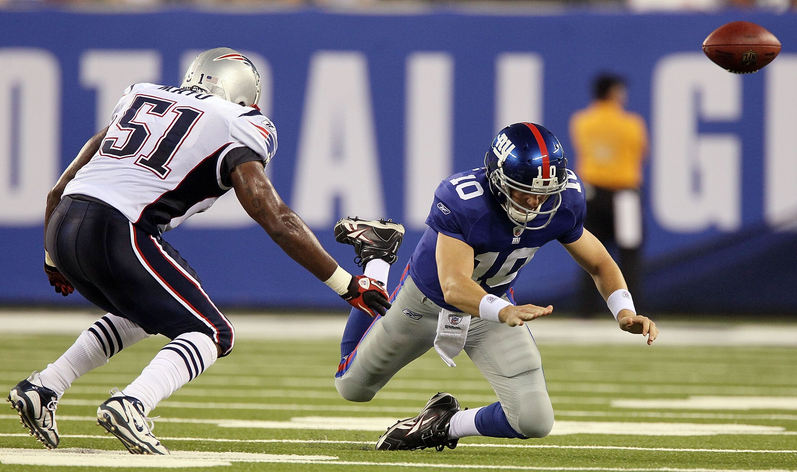 EAST RUTHERFORD, NJ - SEPTEMBER 02: Eli Manning #10 of the New York Giants fumbles the ball in the first quarter as he is pressured by Jerod Mayo #51 of the New England Patriots on September 2, 2010 at the New Meadowlands Stadium in East Rutherford, New EAST RUTHERFORD, NJ - SEPTEMBER 02: Eli Manning #10 of the New York Giants fumbles the ball in the first quarter as he is pressured by Jerod Mayo #51 of the New England Patriots on September 2, 2010 at the New Meadowlands Stadium in East Rutherford, New