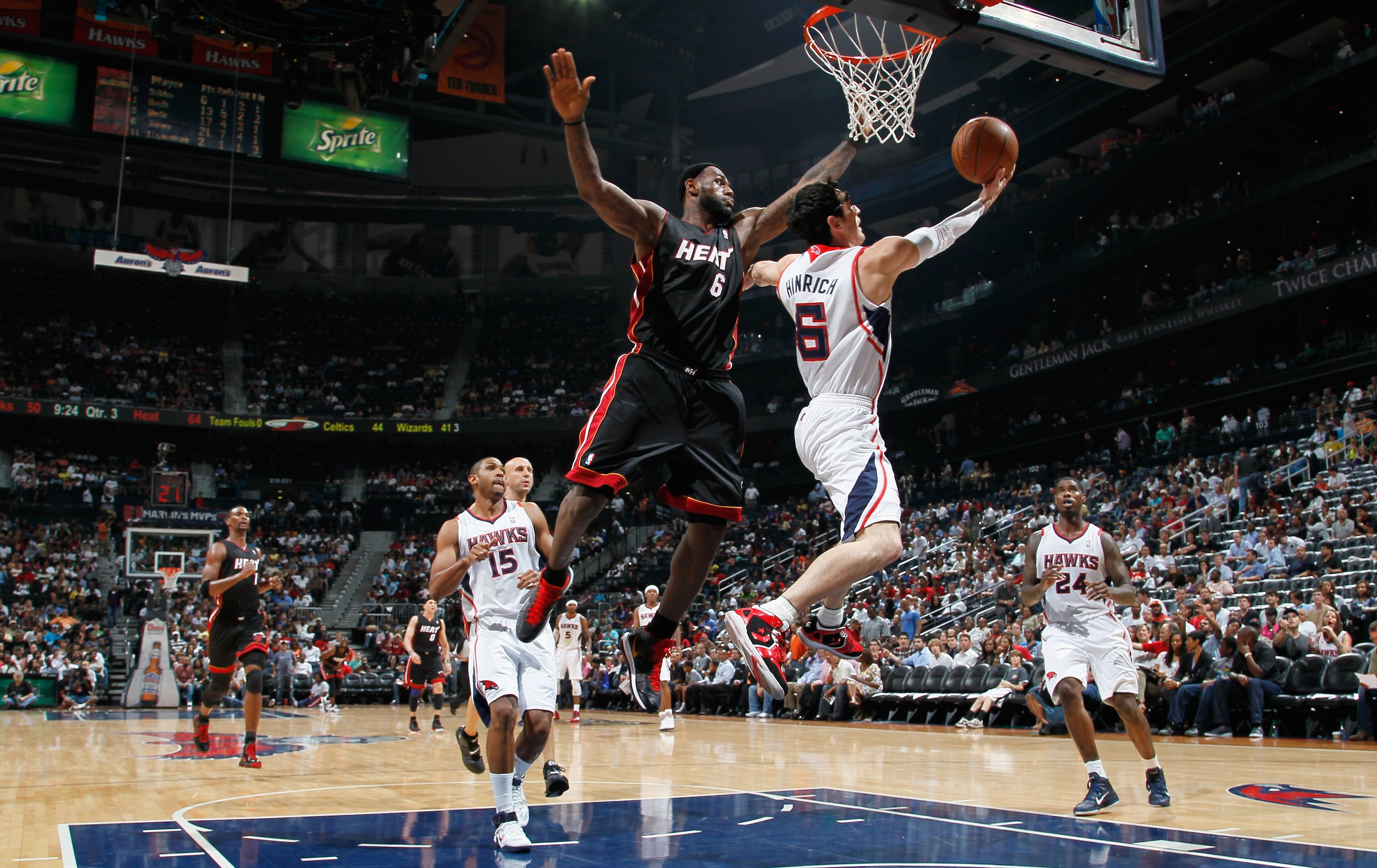 ATLANTA, GA - APRIL 11: Kirk Hinrich #6 of the Atlanta Hawks lays in a basket against LeBron James #6 of the Miami Heat at Philips Arena on April 11, 2011 in Atlanta, Georgia. NOTE TO USER: User expressly acknowledges and agrees that, by downloading and ATLANTA, GA - APRIL 11: Kirk Hinrich #6 of the Atlanta Hawks lays in a basket against LeBron James #6 of the Miami Heat at Philips Arena on April 11, 2011 in Atlanta, Georgia. NOTE TO USER: User expressly acknowledges and agrees that, by downloading and