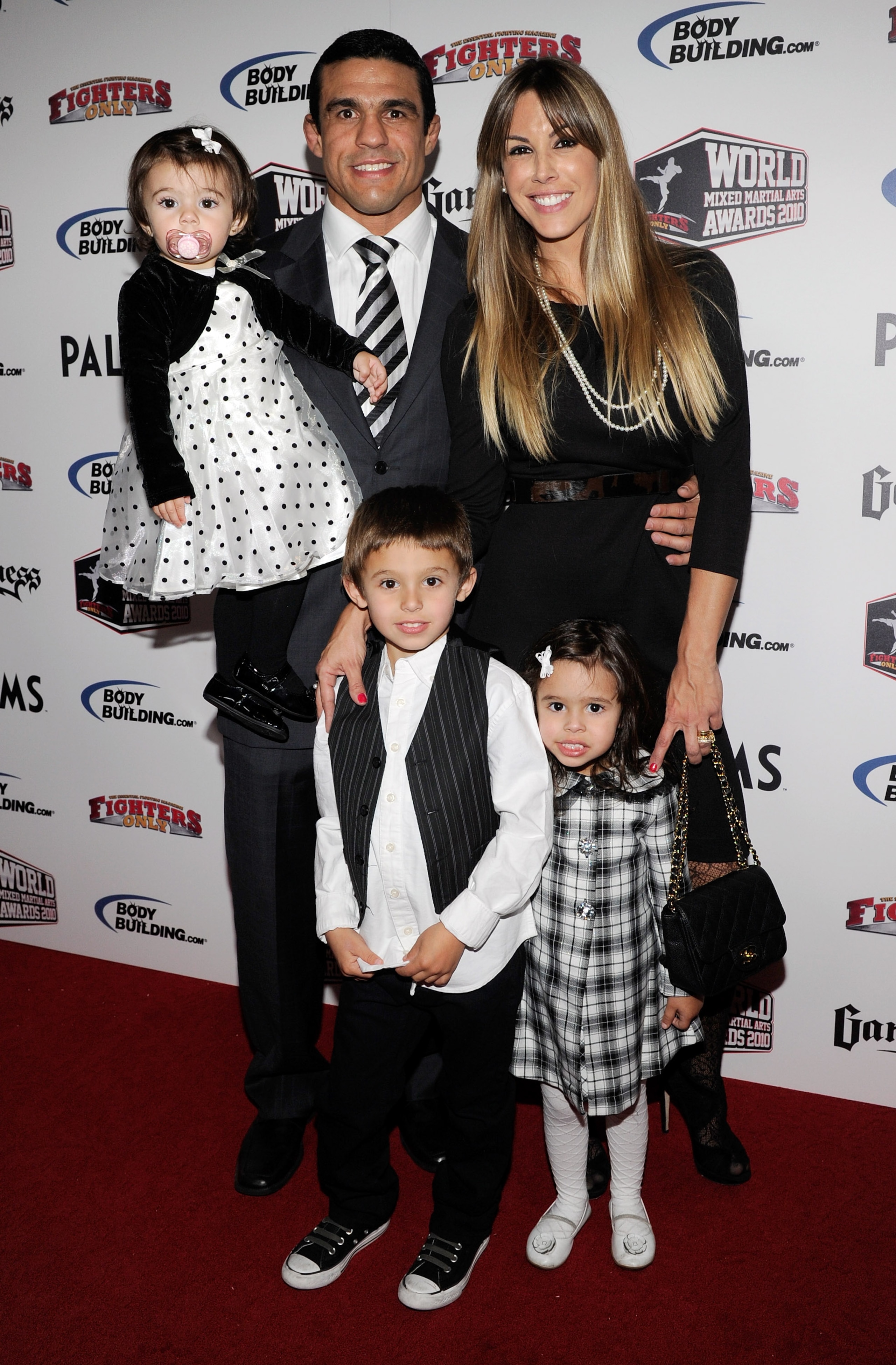 LAS VEGAS, NV - DECEMBER 01:  Mixed martial artist Vitor Belfort holds his daughter Kyara Belfort as he poses with his wife, model Joana Prado, and son Davi Belfort and daughter Vitoria Belfort as they arrive at the third annual Fighters Only World Mixed 