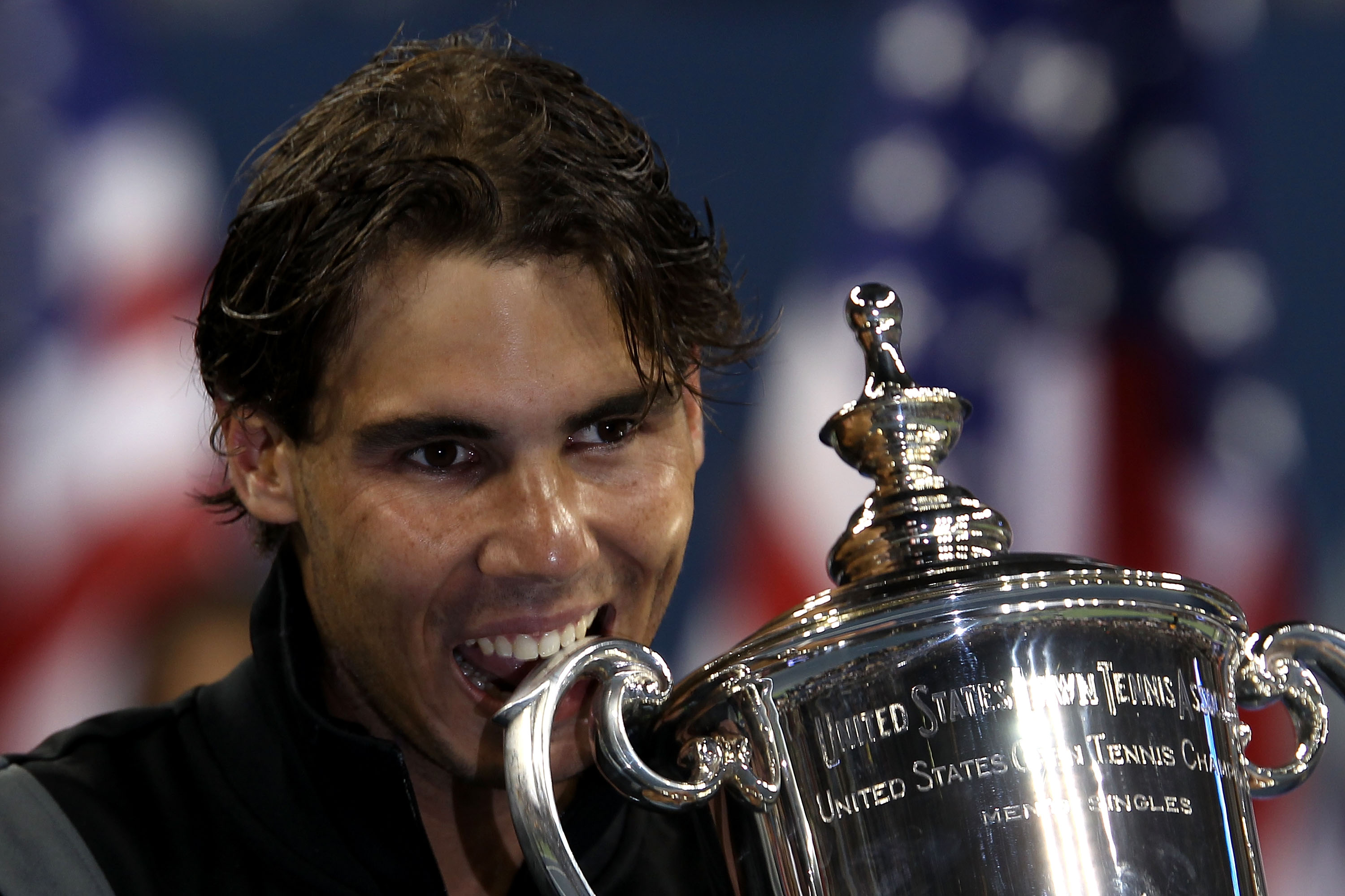 NEW YORK - SEPTEMBER 13:  Rafael Nadal of Spain bites the championship trophy during the trophy ceremony after defeating Novak Djokovic of Serbia to win the men's singles final on day fifteen of the 2010 U.S. Open at the USTA Billie Jean King National Ten