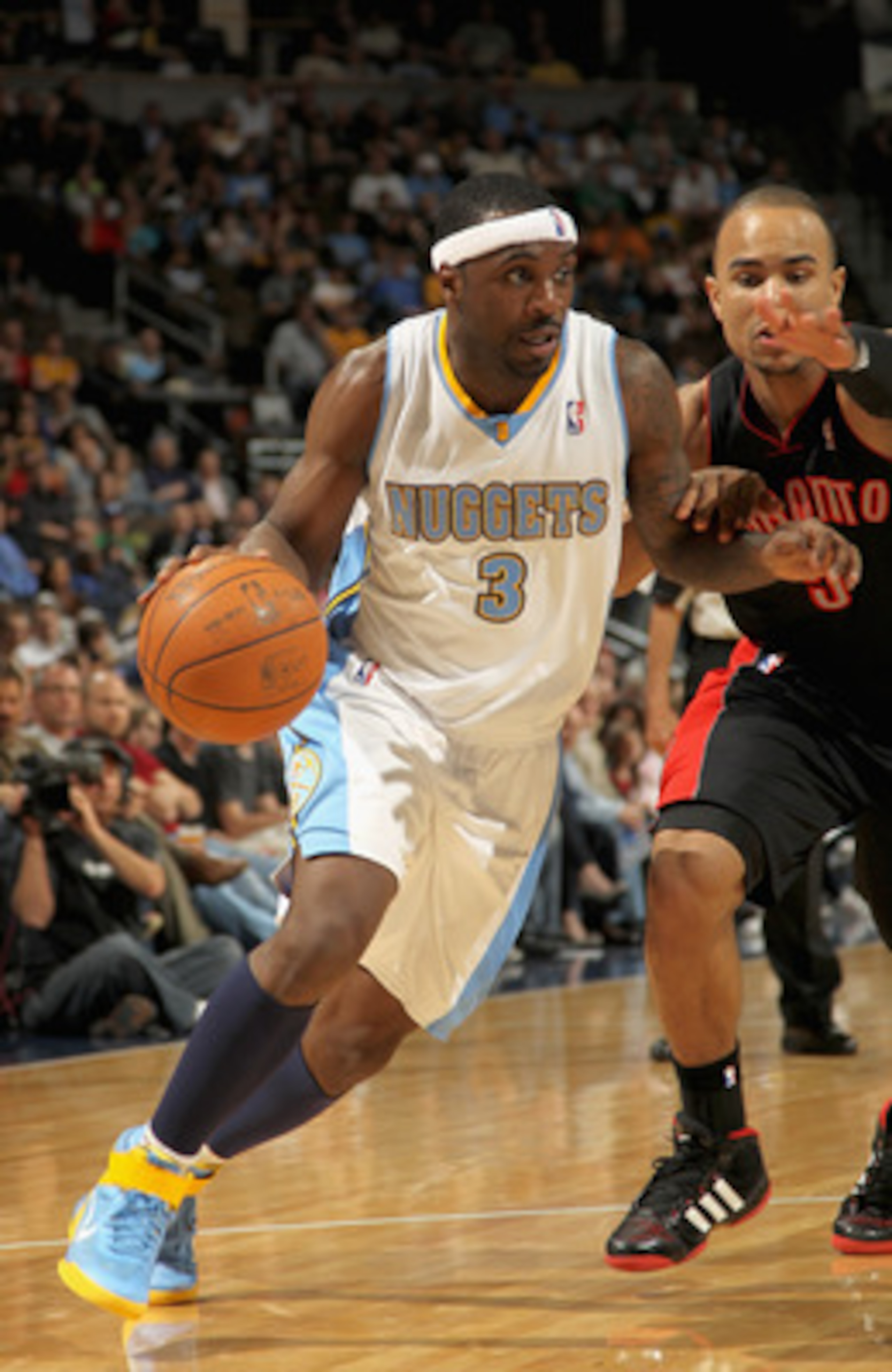 DENVER, CO - MARCH 21:  Ty Lawson #3 of the Denver Nuggets drives to the basket against Jerryd Bayless #5 of the Toronto Raptors at the Pepsi Center on March 21, 2011 in Denver, Colorado. The Nuggets defeated the Raptors 123-90. NOTE TO USER: User express