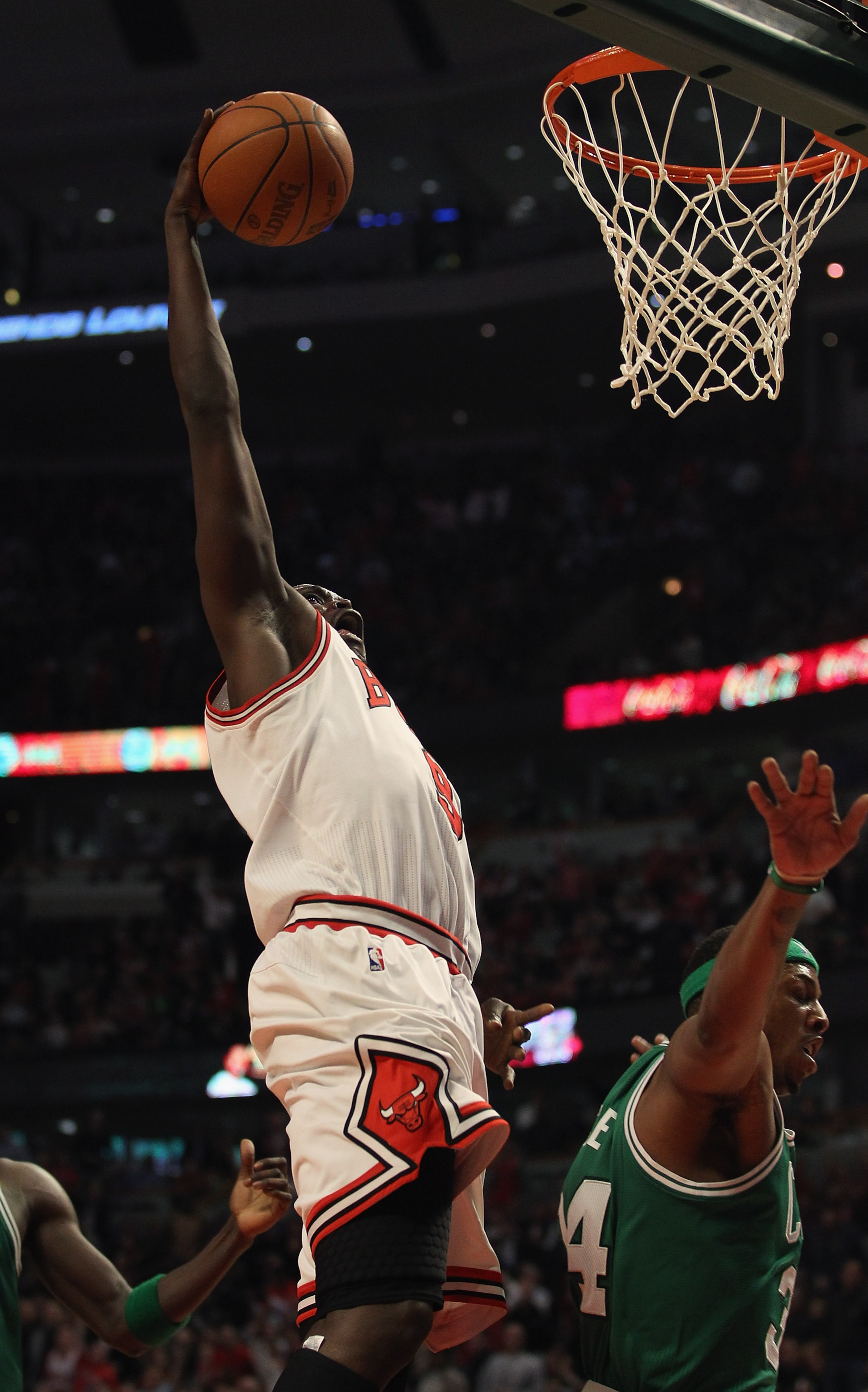 CHICAGO, IL - APRIL 07: Loul Deng #9 of the Chicago Bulls drives to the basket past Paul Pierce #34 of the Boston Celtics at United Center on April 7, 2011 in Chicago, Illinois. The Bulls defeated the Celtics 97-81. NOTE TO USER: User expressly acknowledg