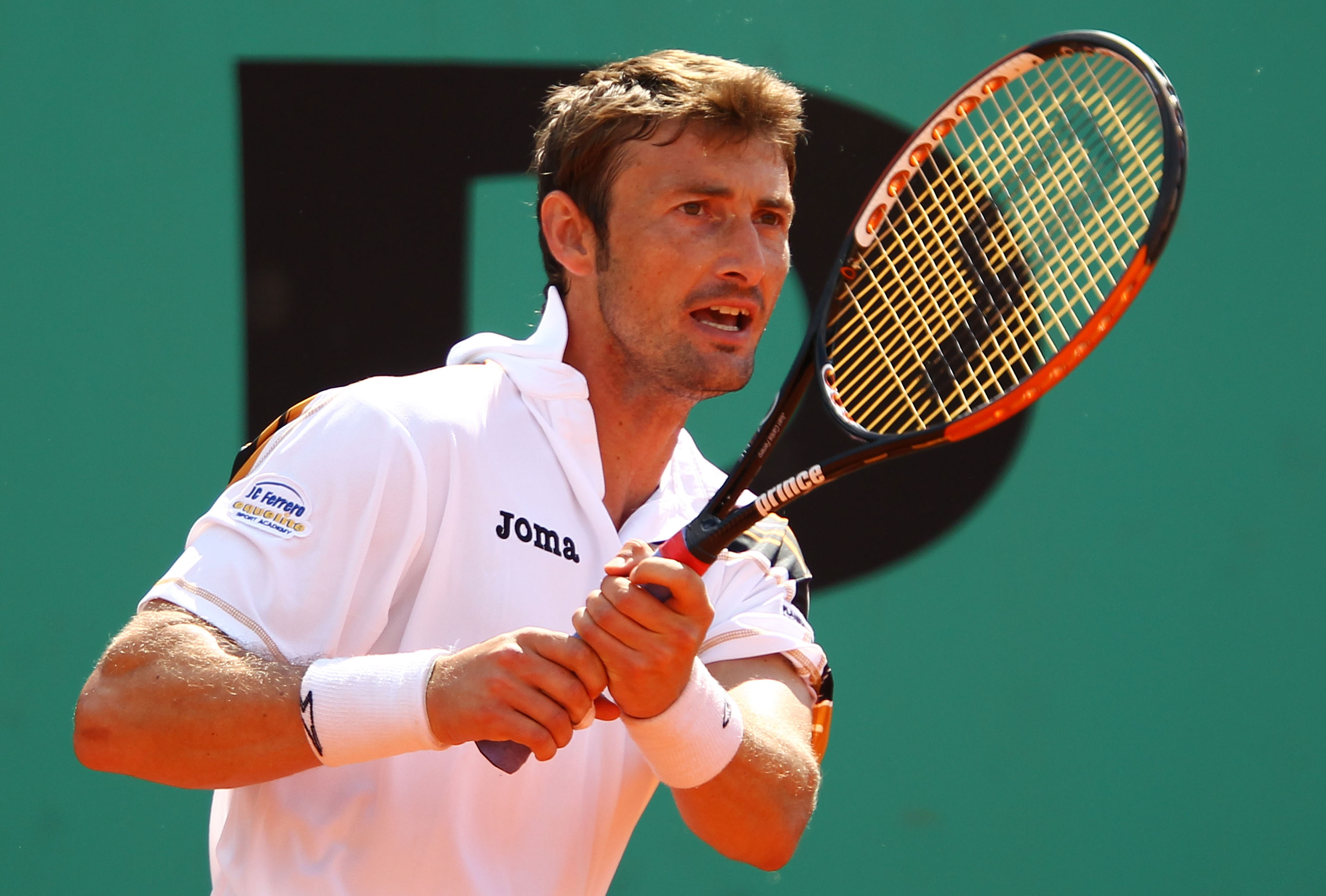 PARIS - MAY 28:  Juan Carlos Ferrero of Spain plays a backhand during the men's singles second round match between Juan Carlos Ferrero of Spain and Pere Riba of Spain on day six of the French Open at Roland Garros on May 28, 2010 in Paris, France.  (Photo
