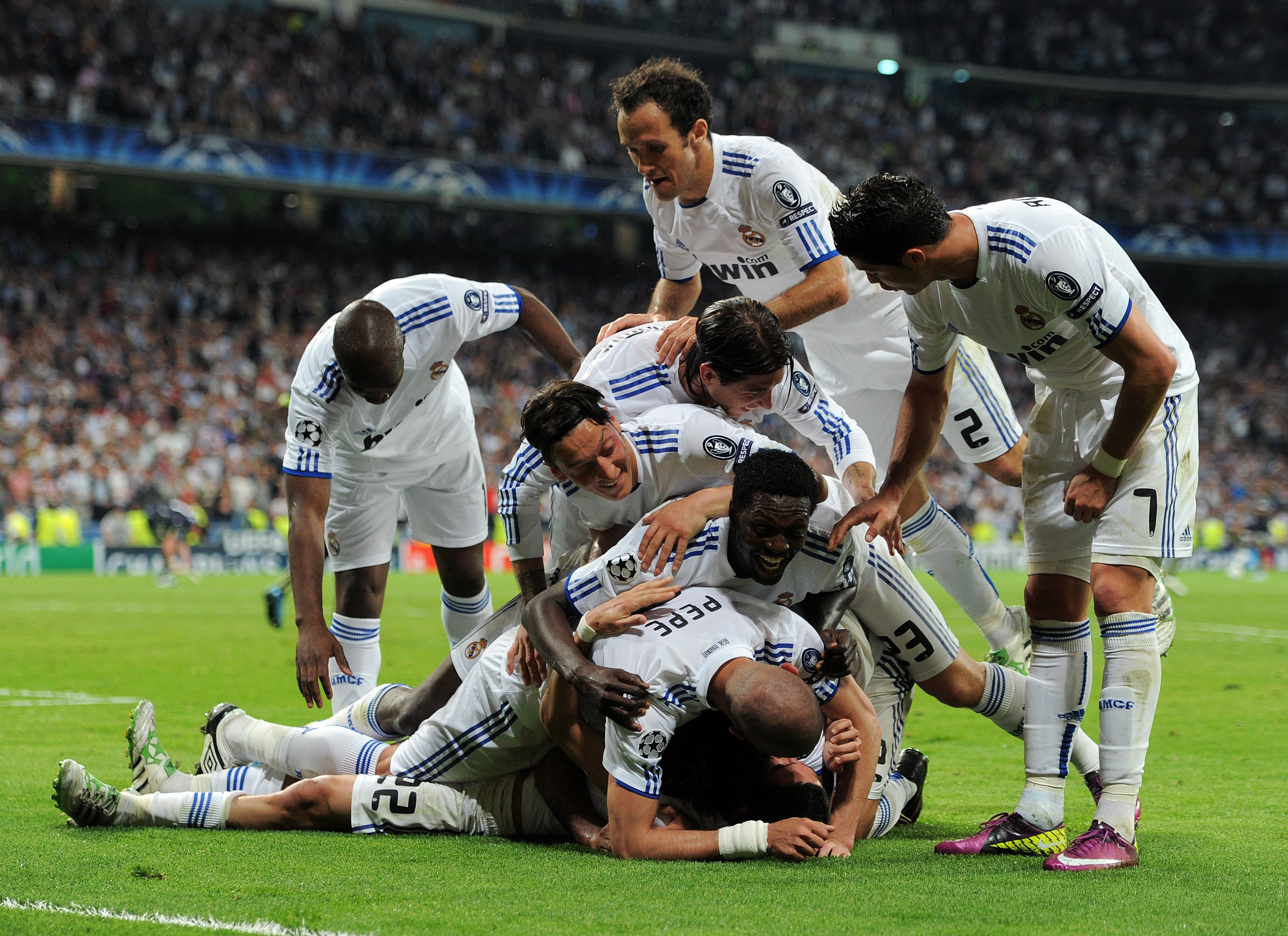 MADRID, SPAIN - APRIL 05:  Real Madrid players celebrate on top of their teammate Angel Di Maria after he scored during the UEFA Champions League quarter final first leg match between Real Madrid and Tottenham Hotspur at Estadio Santiago Bernabeu on April