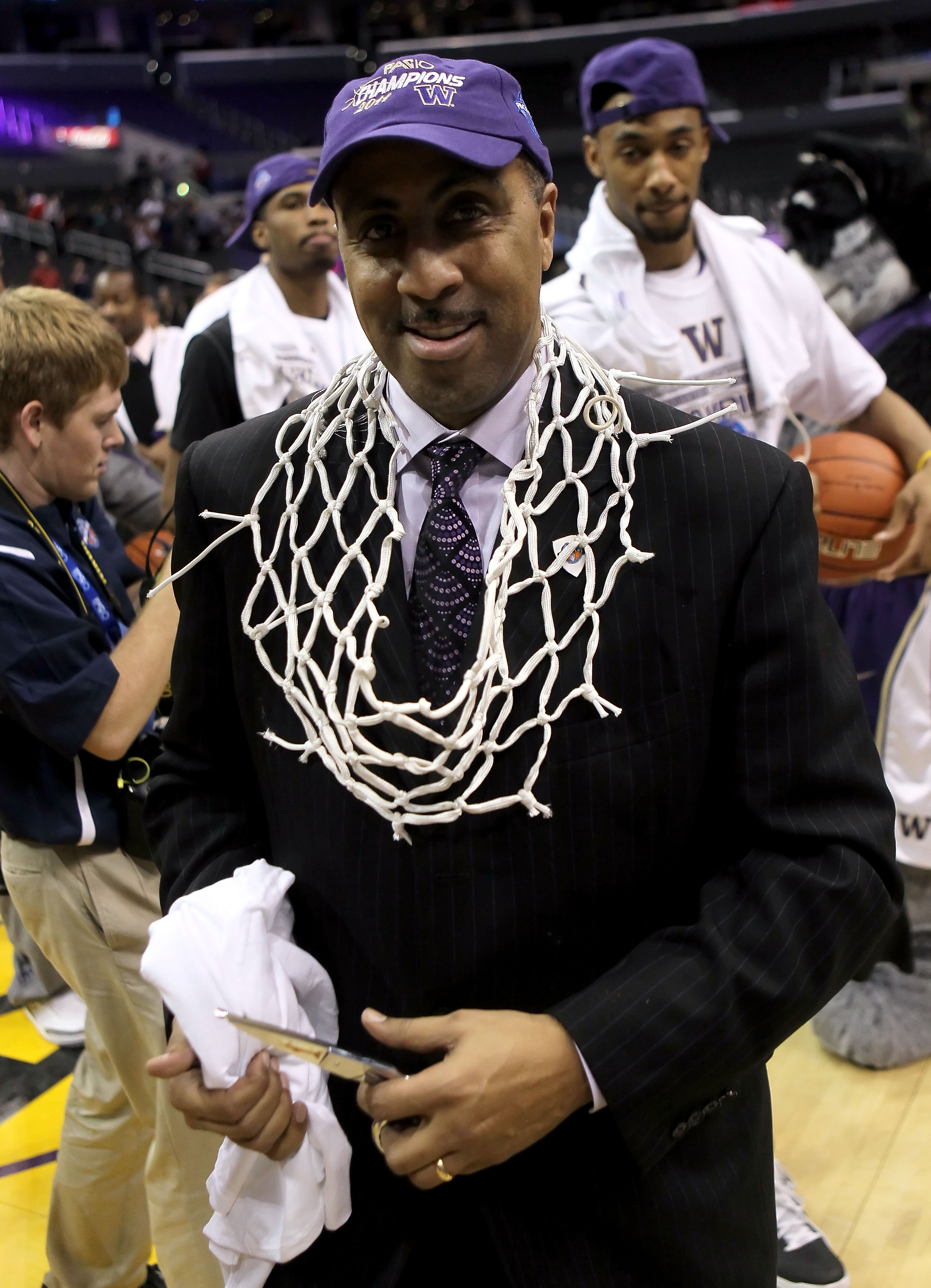 LOS ANGELES, CA - MARCH 12: Head coach Lorenzo Romar of the Washington Huskies celebrates with the net after the Huskies defeated the Arizona Wildcats 77-75 in the championship game of the 2011 Pacific Life Pac-10 Men's Basketball Tournament at Staples C