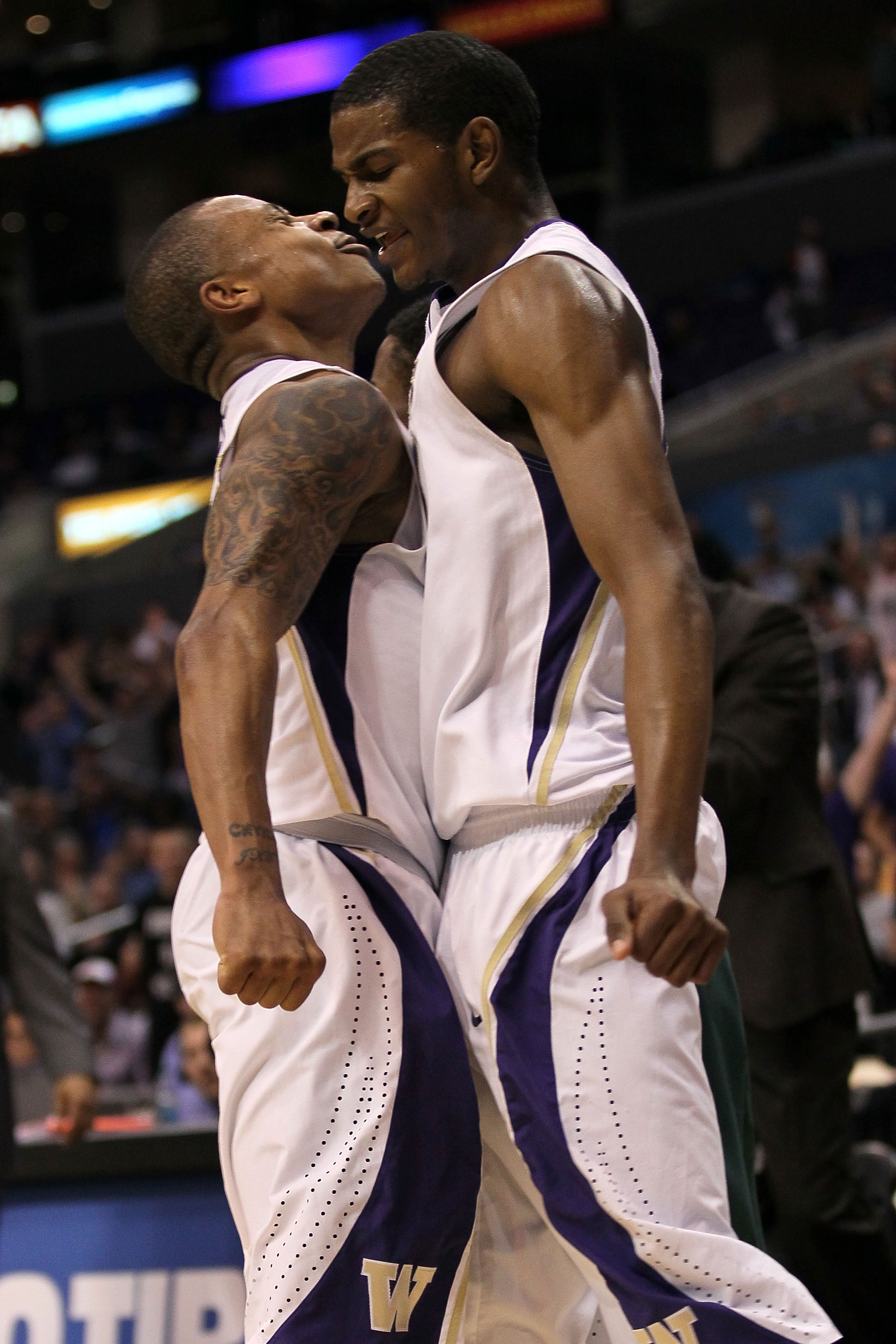 LOS ANGELES, CA - MARCH 11: Isaiah Thomas #2 and C.J. Wilcox #23 of the Washington Huskies celebrate late in the second half while taking on the Oregon Ducks in the semifinals of the 2011 Pacific Life Pac-10 Men's Basketball Tournament at Staples Center