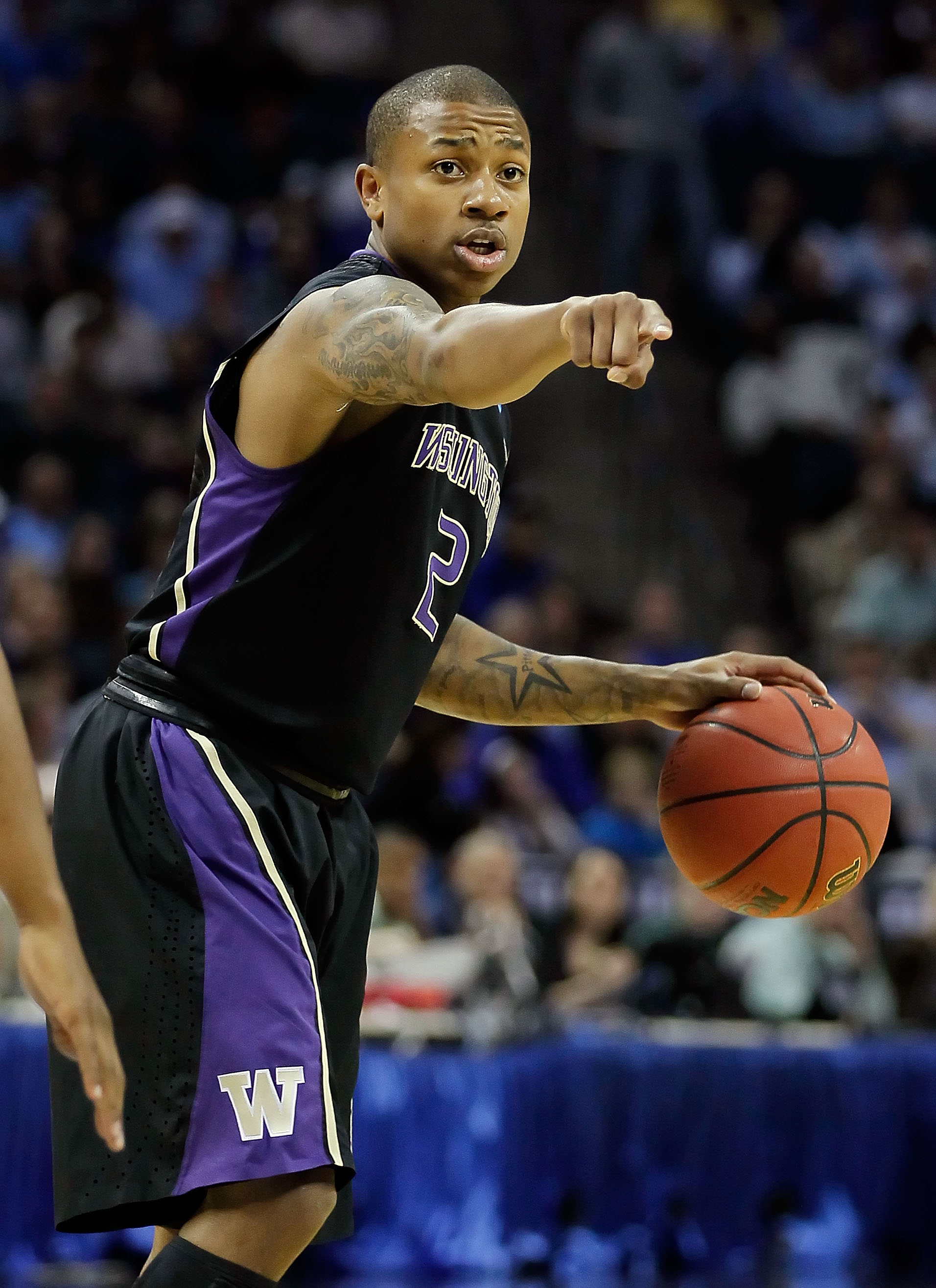 CHARLOTTE, NC - MARCH 20: Isaiah Thomas #2 of the Washington Huskies points in the first half while taking on the North Carolina Tar Heels during the third round of the 2011 NCAA men's basketball tournament at Time Warner Cable Arena on March 20, 2011 in
