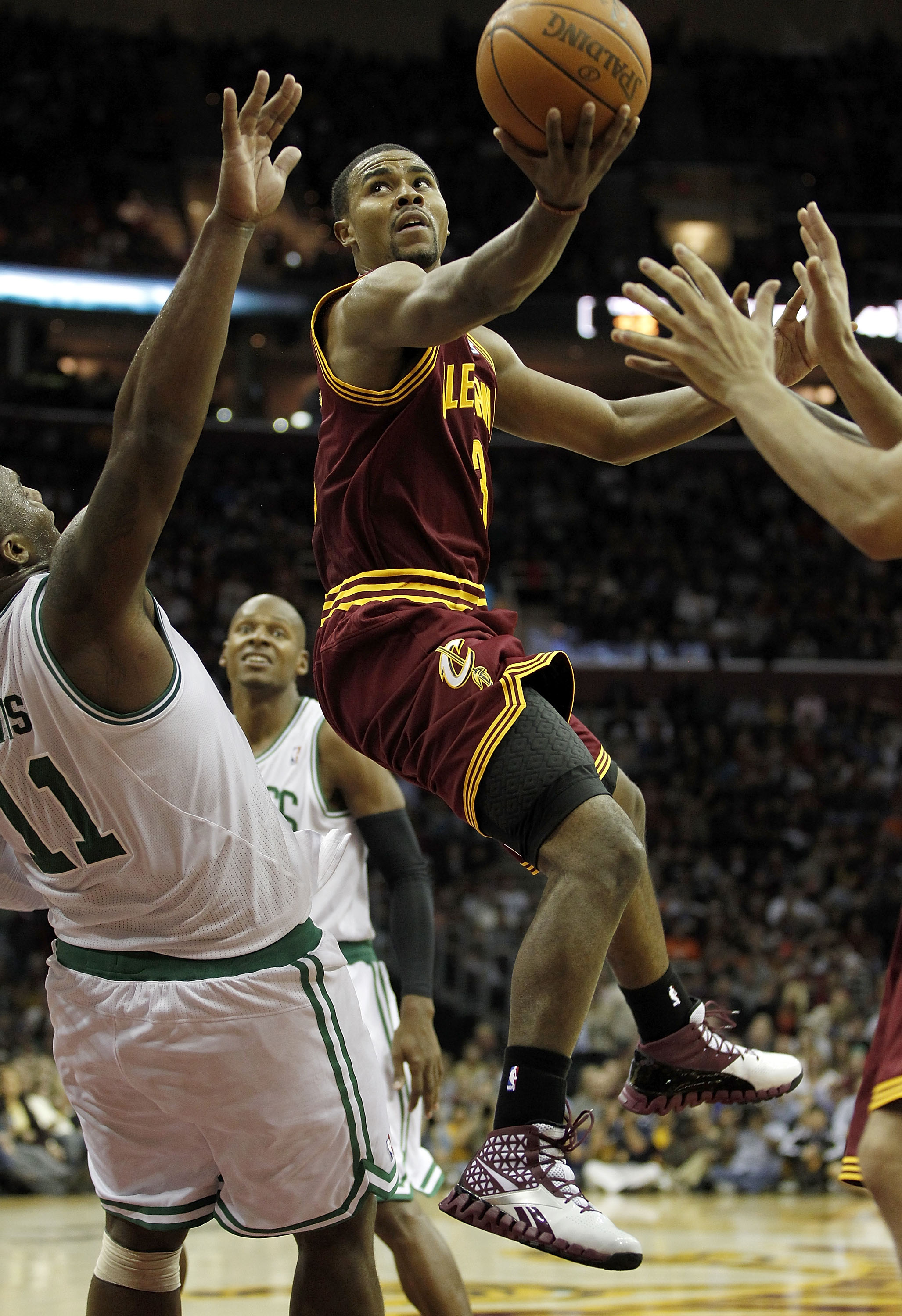 CLEVELAND - OCTOBER 27:  Ramon Sessions #3 of the Cleveland Cavaliers tries to get a shot off around Glen Davis #11 of the Boston Celtics at Quicken Loans Arena on October 27, 2010 in Cleveland, Ohio. Cleveland won the game 95-87.  (Photo by Gregory Shamu