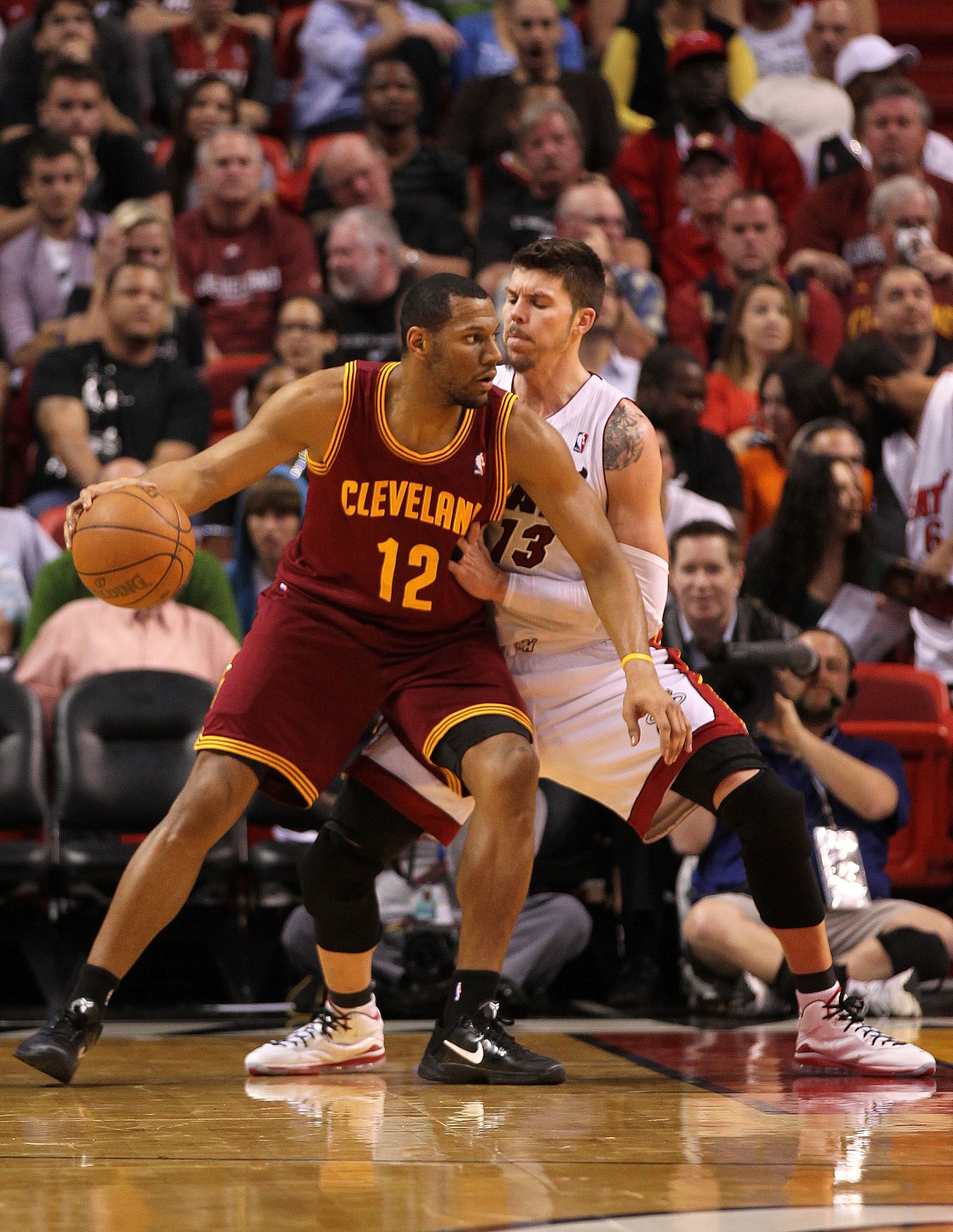 MIAMI, FL - JANUARY 31: Joey Graham #12 of the Cleveland Cavaliers posts up Mike Miller #13 of the Miami Heat  during a game at American Airlines Arena on January 31, 2011 in Miami, Florida. NOTE TO USER: User expressly acknowledges and agrees that, by do