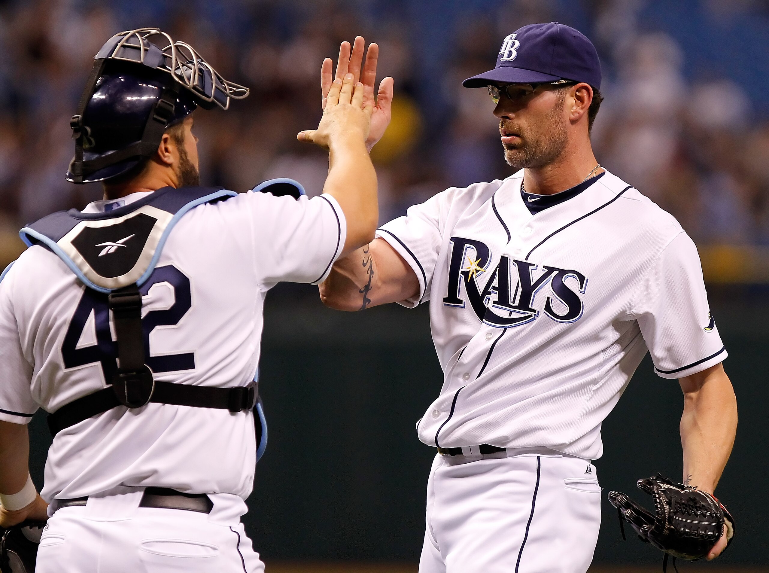 ST. PETERSBURG, FL - APRIL 15:  Pitcher Kyle Farnsworth #43 of the Tampa Bay Rays celebrates the last out with catcher Kelly Shoppach #10 during a game against the Minnesota Twins at Tropicana Field on April 15, 2011 in St. Petersburg, Florida.  (Photo by