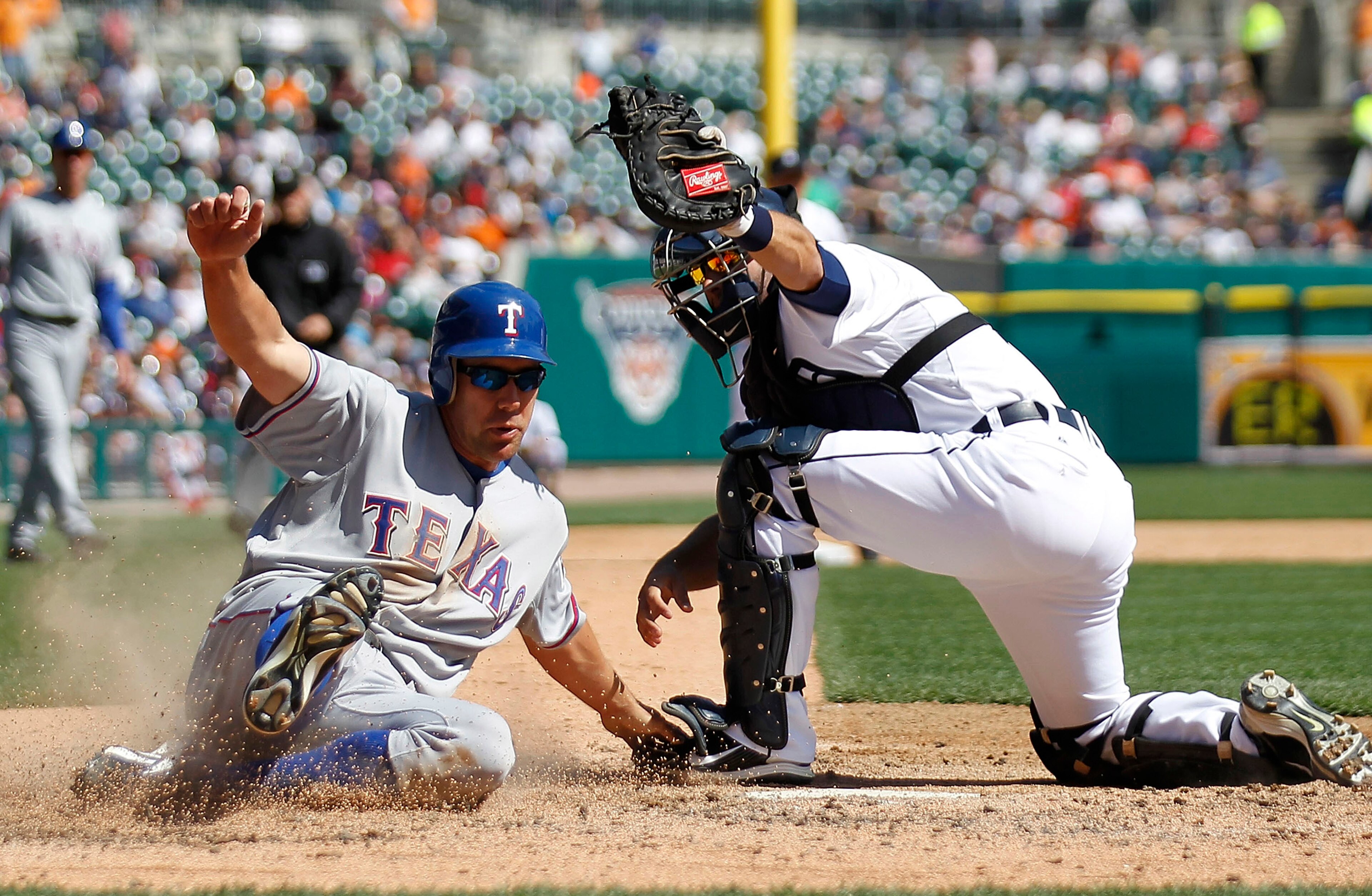 DETROIT - APRIL 13:  David Murphy #7 of the Texas Rangers is tagged out at home by Alex Avila #13 of the Detroit Tigers in the seventh inning during the game at Comerica Park on April 13, 2011 in Detroit, Michigan. The Tigers defeated the Rangers 3-2. (Ph