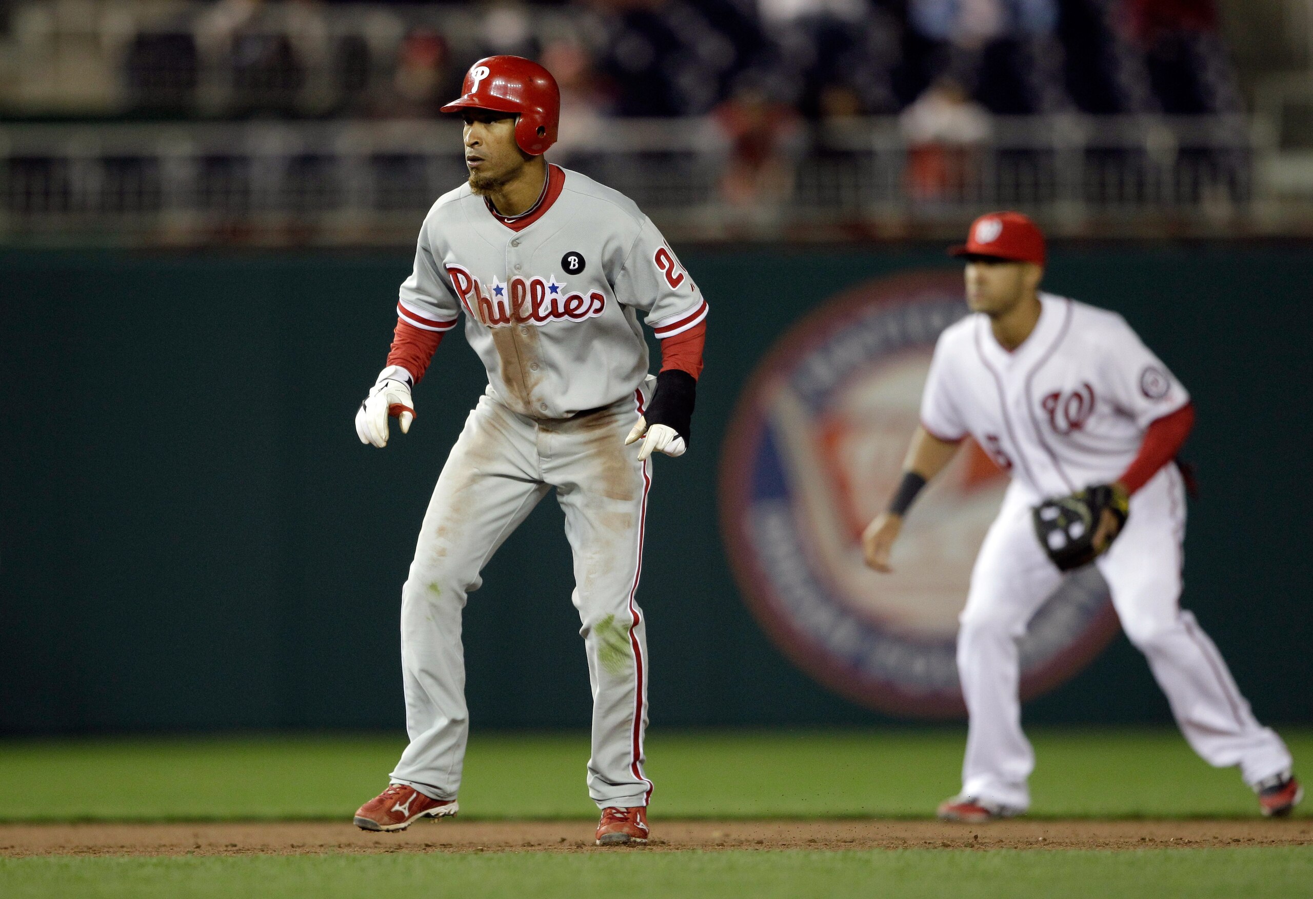 WASHINGTON, DC - APRIL 12: Wilson Valdez #21 of the Philadelphia Phillies leads off as shortstop Ian Desmond #6 of the Washington Nationals looks at Nationals Park on April 12, 2011 in Washington, DC. (Photo by Rob Carr/Getty Images)