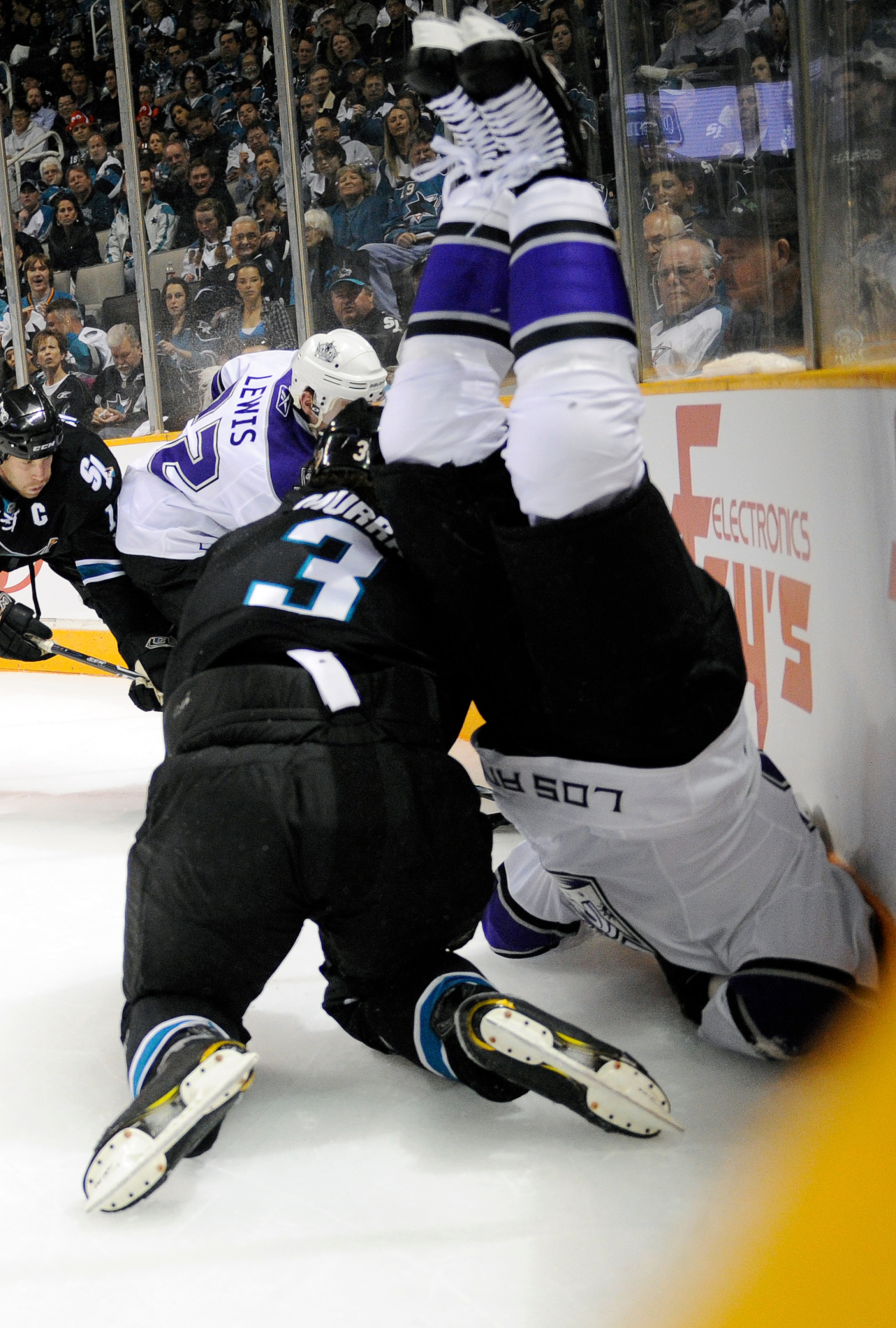 SAN JOSE, CA - APRIL 14: Dustin Brown #23 of the Los Angeles Kings flips over Douglas Murray #3 of the San Jose Sharks in Game One of the Western Conference Quarterfinals during the 2011 NHL Stanley Cup Playoffs at the HP Pavilion on April 14, 2011 in Sa SAN JOSE, CA - APRIL 14: Dustin Brown #23 of the Los Angeles Kings flips over Douglas Murray #3 of the San Jose Sharks in Game One of the Western Conference Quarterfinals during the 2011 NHL Stanley Cup Playoffs at the HP Pavilion on April 14, 2011 in Sa