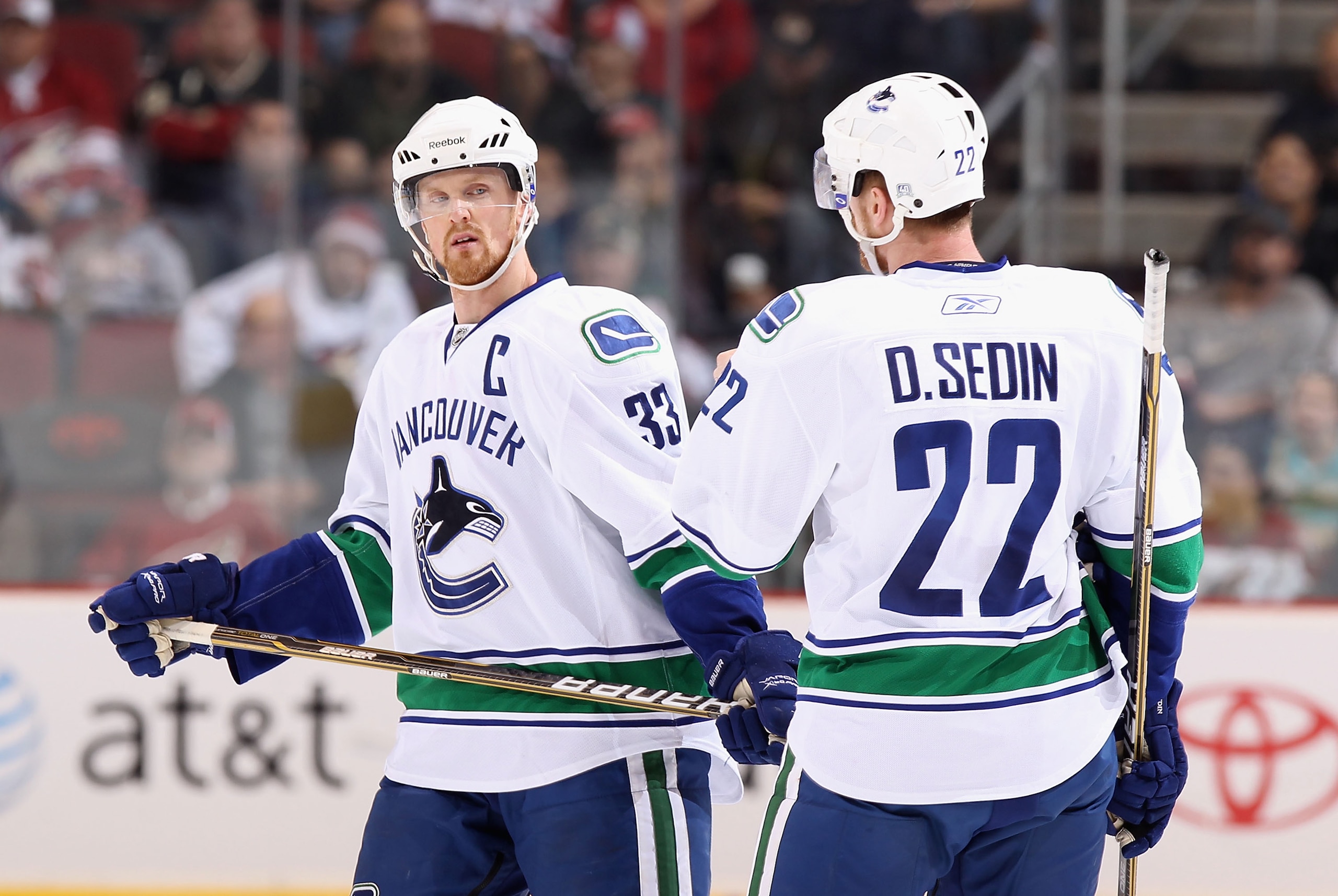 GLENDALE, AZ - MARCH 08: Henrik Sedin #33 and Daniel Sedin #22 of the Vancouver Canucks talk during the NHL game against the Phoenix Coyotes at Jobing.com Arena on March 8, 2011 in Glendale, Arizona. The Canucks defeated the Coyotes 4-3 in overtime. (Pho GLENDALE, AZ - MARCH 08: Henrik Sedin #33 and Daniel Sedin #22 of the Vancouver Canucks talk during the NHL game against the Phoenix Coyotes at Jobing.com Arena on March 8, 2011 in Glendale, Arizona. The Canucks defeated the Coyotes 4-3 in overtime. (Pho