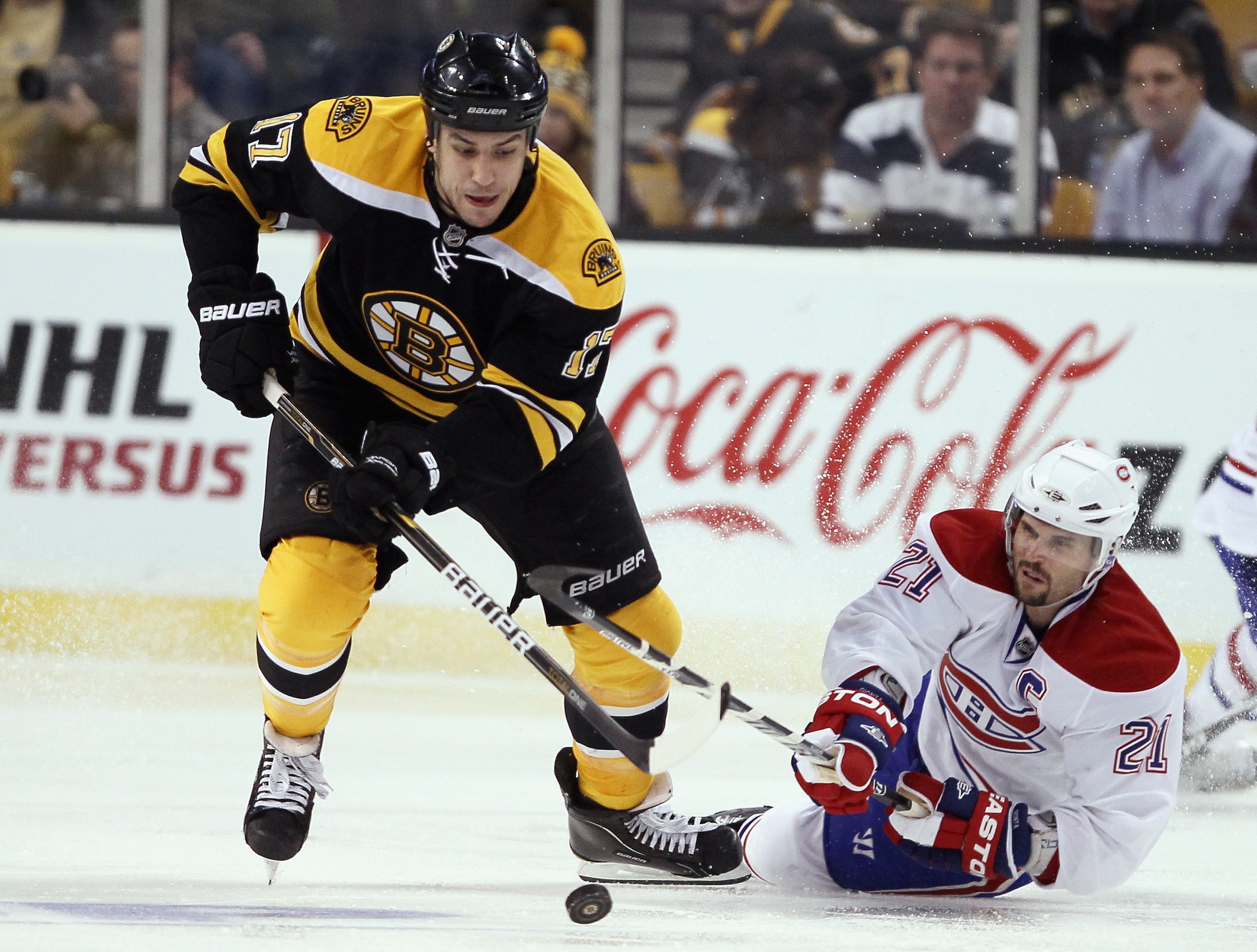 BOSTON, MA - APRIL 14: Milan Lucic #17 of the Boston Bruins steals the puck from Brian Gionta #21 of the Montreal Canadiens in Game One of the Eastern Conference Quarterfinals during the 2011 NHL Stanley Cup Playoffs at TD Garden on April 14, 2011 in Bos BOSTON, MA - APRIL 14: Milan Lucic #17 of the Boston Bruins steals the puck from Brian Gionta #21 of the Montreal Canadiens in Game One of the Eastern Conference Quarterfinals during the 2011 NHL Stanley Cup Playoffs at TD Garden on April 14, 2011 in Bos