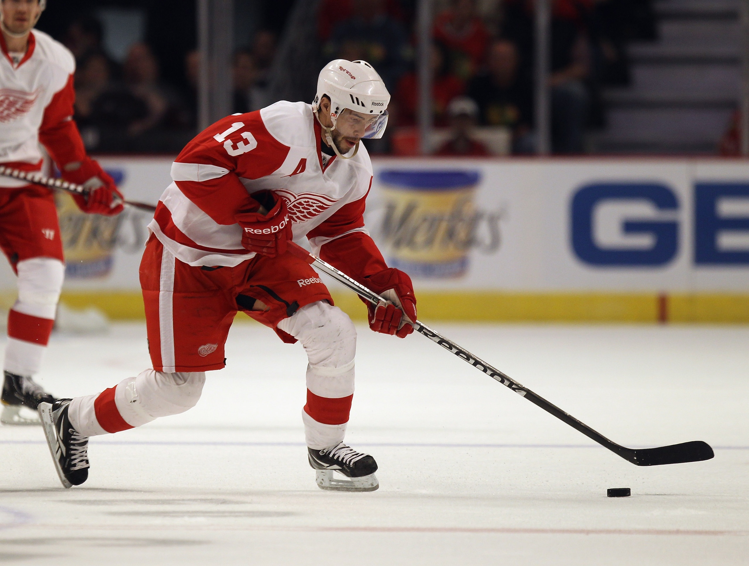 CHICAGO, IL - APRIL 10: Pavel Datsyuk #13 of the Detroit Red Wings skates to the puck against the Chicago Blackhawks at the United Center on April 10, 2011 in Chicago, Illinois. The Red Wings defeated the Blackhawks 4-3. (Photo by Jonathan Daniel/Getty Im CHICAGO, IL - APRIL 10: Pavel Datsyuk #13 of the Detroit Red Wings skates to the puck against the Chicago Blackhawks at the United Center on April 10, 2011 in Chicago, Illinois. The Red Wings defeated the Blackhawks 4-3. (Photo by Jonathan Daniel/Getty Im