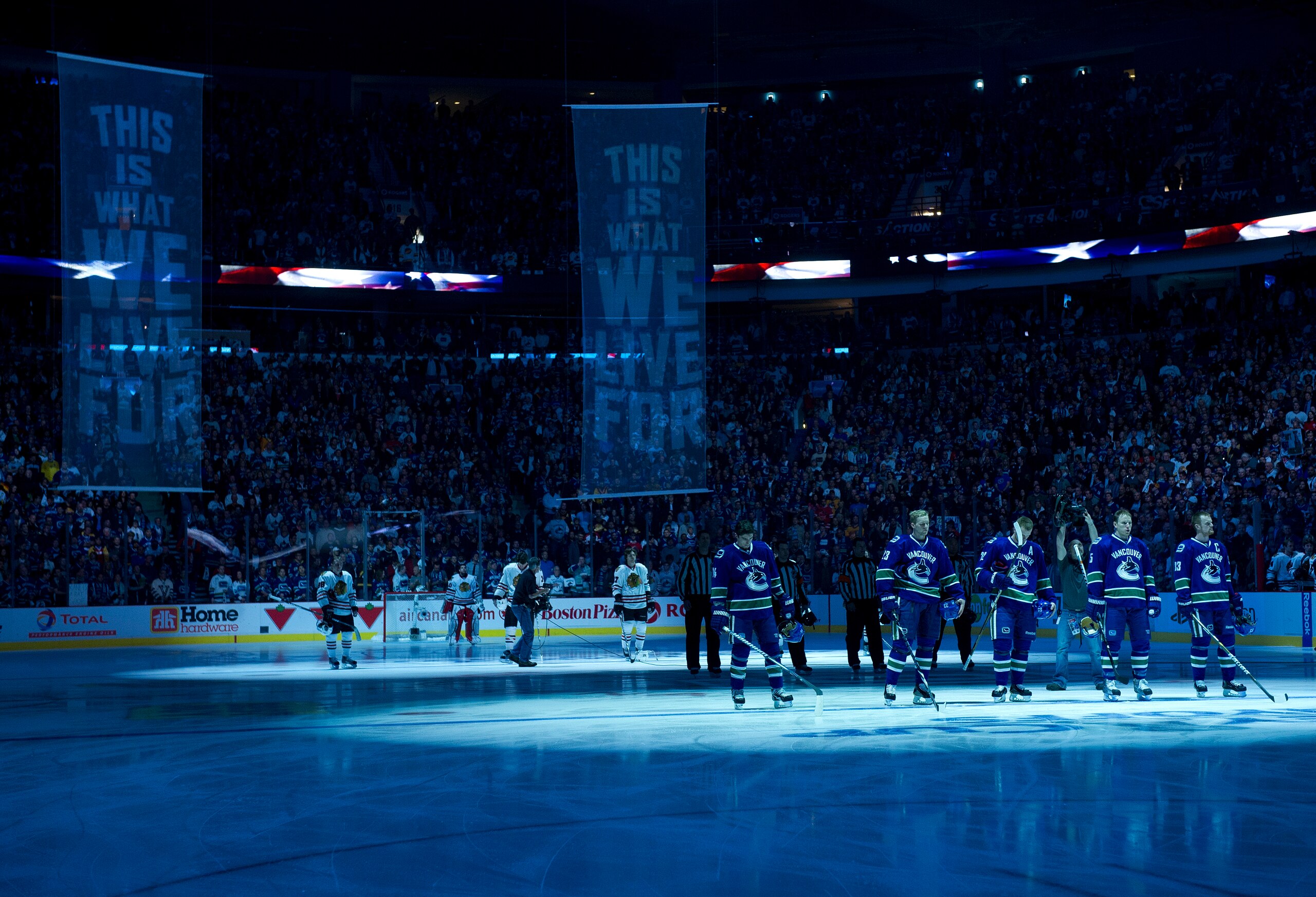 VANCOUVER, CANADA - APRIL 15: The Vancouver Canucks and the Chicago Blackhawks stand on their respective blue lines for the singing of the national anthems prior to the start of Game Two of the Western Conference Quarterfinals during the 2011 NHL Stanley VANCOUVER, CANADA - APRIL 15: The Vancouver Canucks and the Chicago Blackhawks stand on their respective blue lines for the singing of the national anthems prior to the start of Game Two of the Western Conference Quarterfinals during the 2011 NHL Stanley