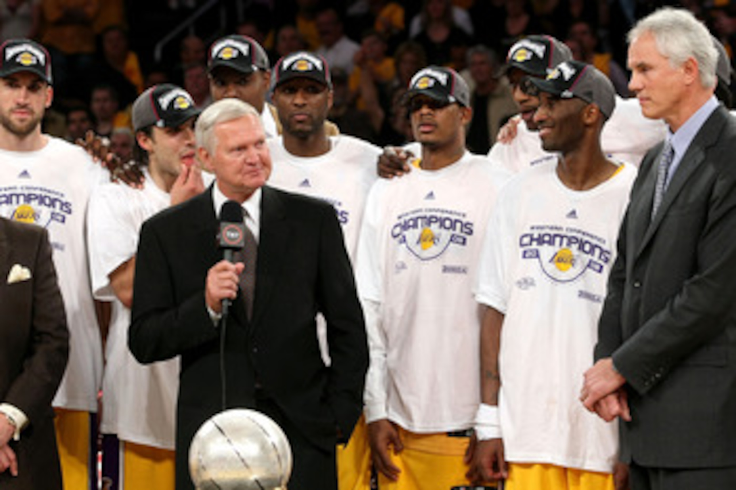 LOS ANGELES, CA - MAY 29: Los Angeles Lakers legend Jerry West presents the Western Conference Championship trophy to General Manager Mitch Kupchak of the Los Angeles Lakers after they defeated the San Antonio Spurs in Game Five of the Western Conference LOS ANGELES, CA - MAY 29: Los Angeles Lakers legend Jerry West presents the Western Conference Championship trophy to General Manager Mitch Kupchak of the Los Angeles Lakers after they defeated the San Antonio Spurs in Game Five of the Western Conference