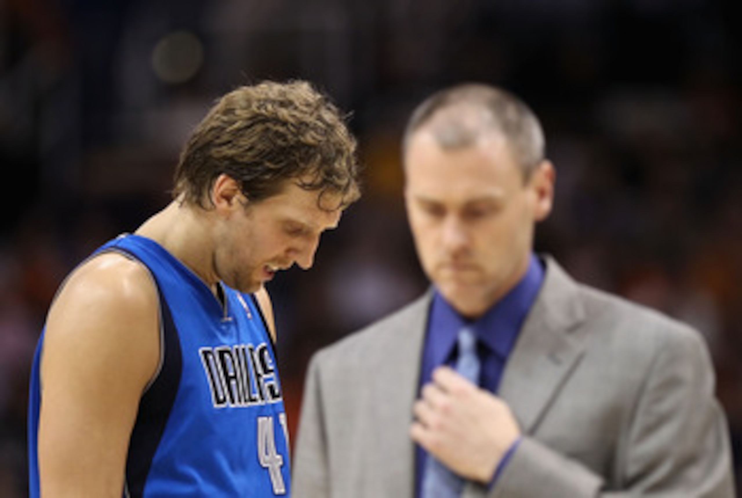 PHOENIX, AZ - MARCH 27: Dirk Nowitzki #41 of the Dallas Mavericks walks by head coach Rick Carlisle during the NBA game against the Phoenix Suns at US Airways Center on March 27, 2011 in Phoenix, Arizona. The Mavericks defeated the Suns 91-83. NOTE TO PHOENIX, AZ - MARCH 27: Dirk Nowitzki #41 of the Dallas Mavericks walks by head coach Rick Carlisle during the NBA game against the Phoenix Suns at US Airways Center on March 27, 2011 in Phoenix, Arizona. The Mavericks defeated the Suns 91-83. NOTE TO