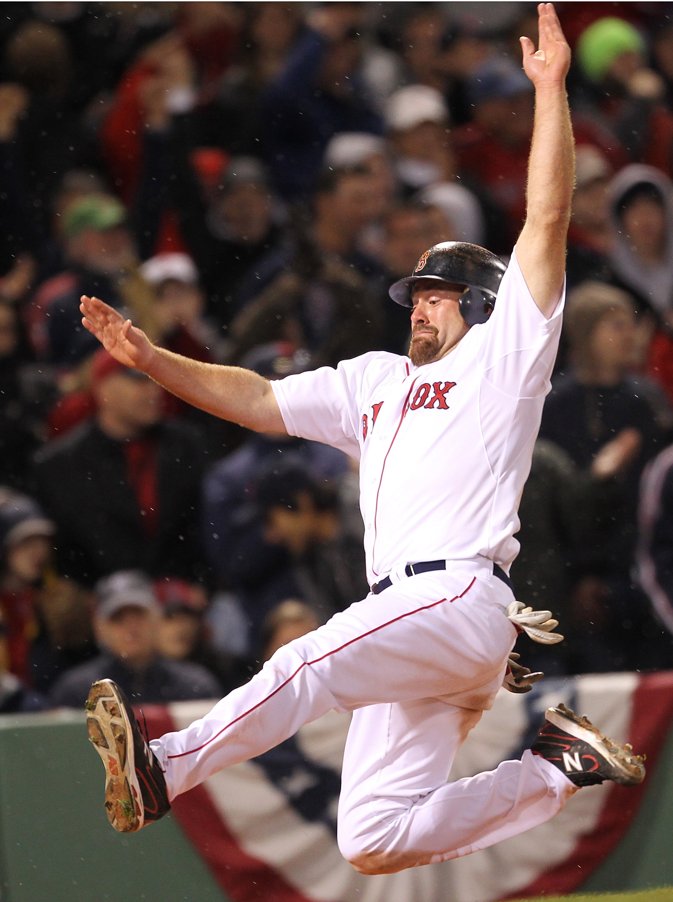BOSTON, MA - APRIL 10:  Kevin Youkilis #20 of the Boston Red Sox scores a run on a double hit by  David Ortiz against the New York Yankees in the seventh inning at Fenway Park April 10, 2011 in Boston, Massachusetts. (Photo by Jim Rogash/Getty Images)