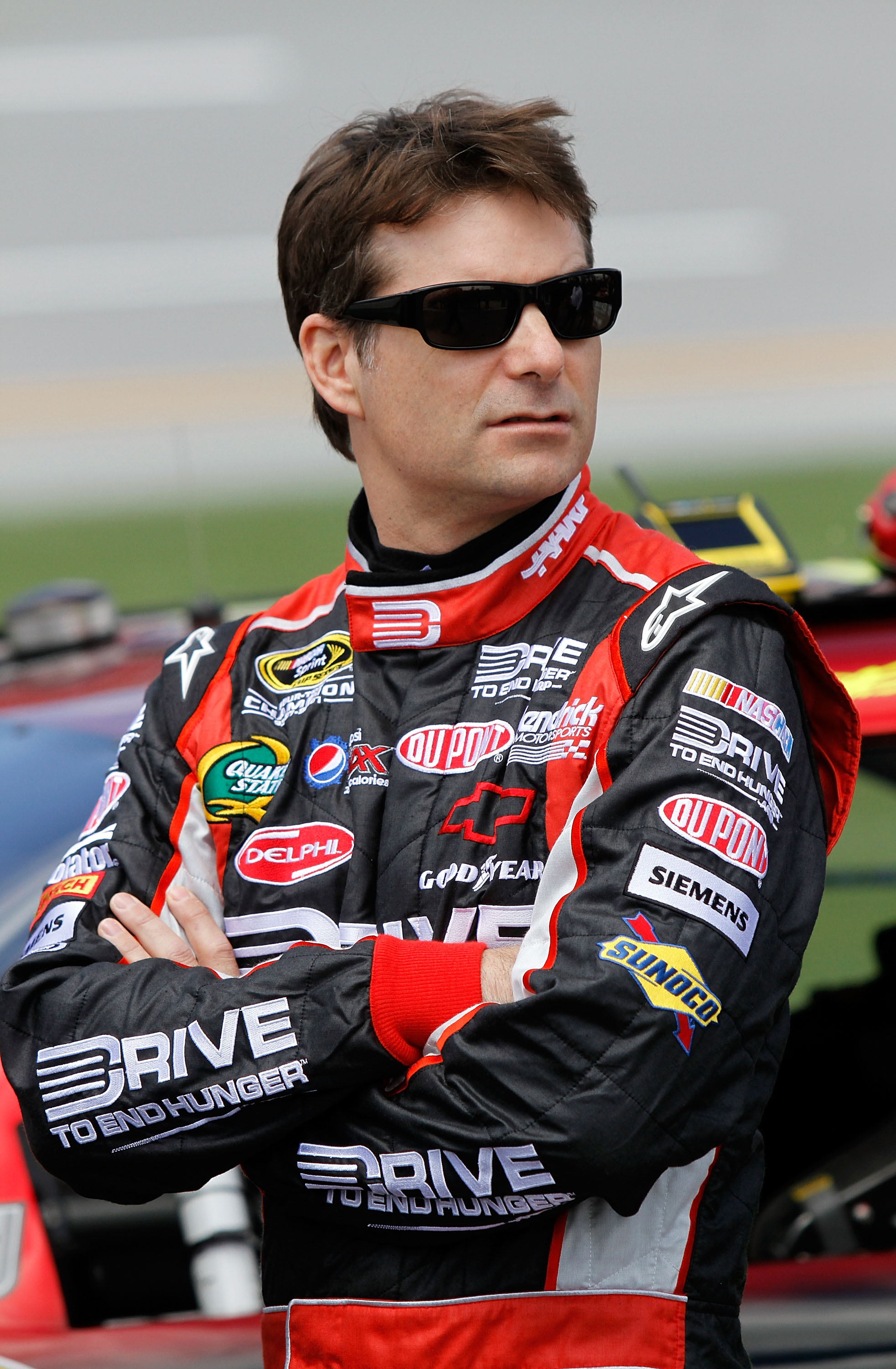 TALLADEGA, AL - APRIL 16:  Jeff Gordon, driver of the #24 Drive to End Hunger/AARP Chevrolet, stands on the grid during qualifying for the NASCAR Sprint Cup Series Aaron's 499 at Talladega Superspeedway on April 16, 2011 in Talladega, Alabama.  (Photo by