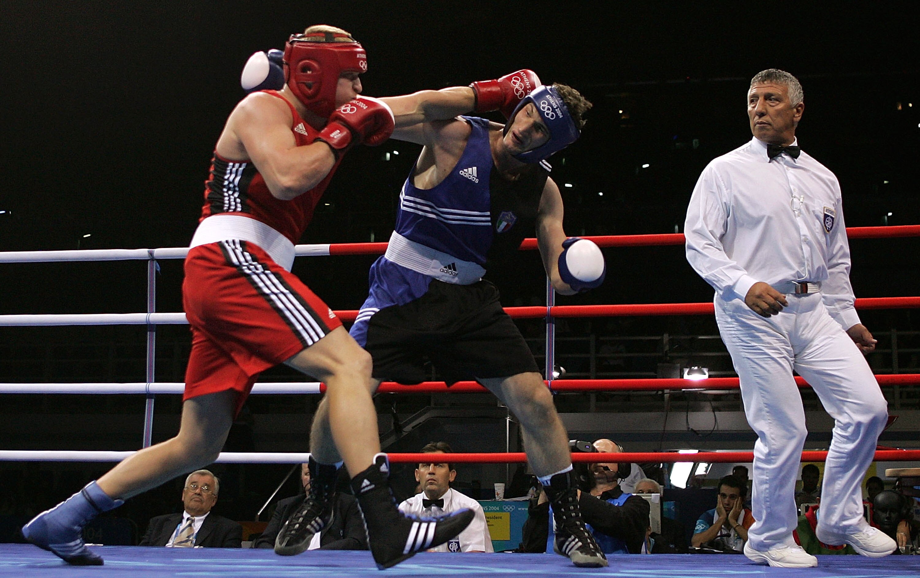 ATHENS - AUGUST 27:  Roberto Cammarelle (blue) of Italy and Alexander Povetkin of Russia trade punches during the men's boxing +91 kg semifinal bout on August 27, 2004 during the Athens 2004 Summer Olympic Games at Peristeri Olympic Boxing Hall in Athens,
