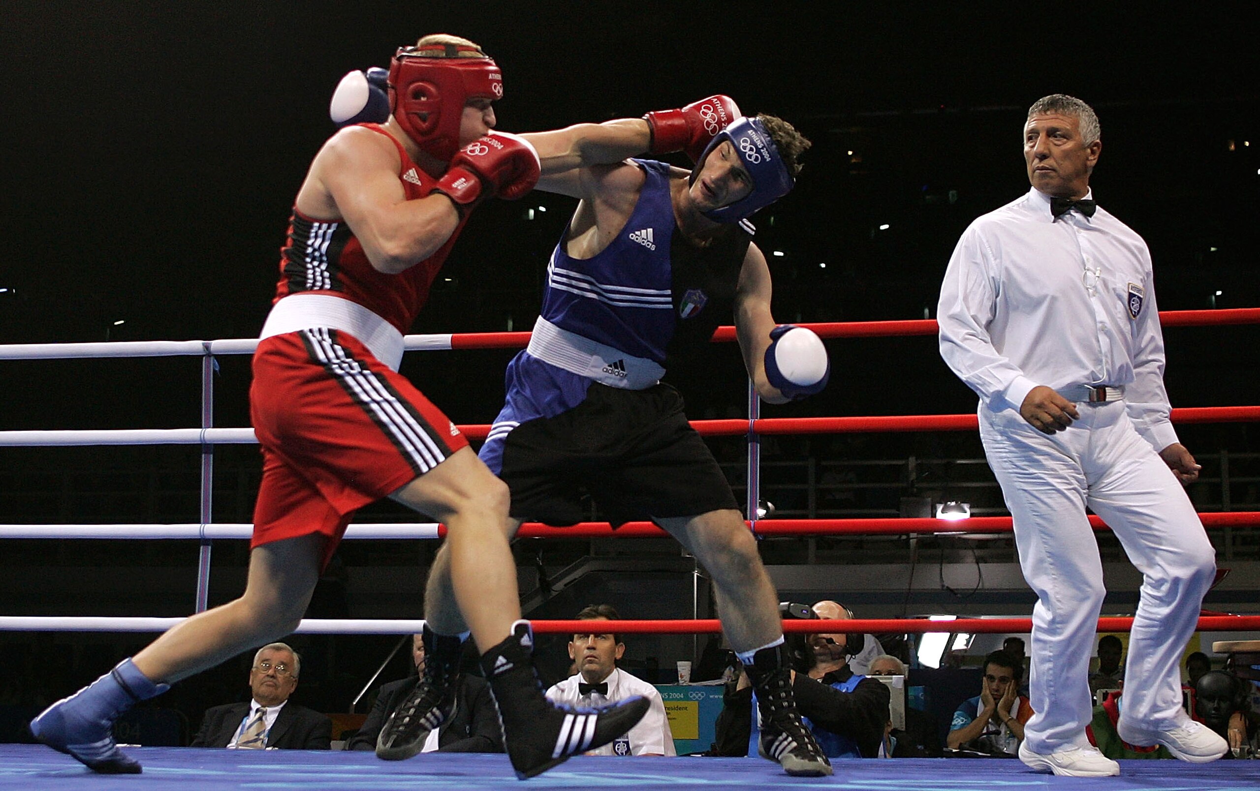 ATHENS - AUGUST 27:  Roberto Cammarelle (blue) of Italy and Alexander Povetkin of Russia trade punches during the men's boxing +91 kg semifinal bout on August 27, 2004 during the Athens 2004 Summer Olympic Games at Peristeri Olympic Boxing Hall in Athens,