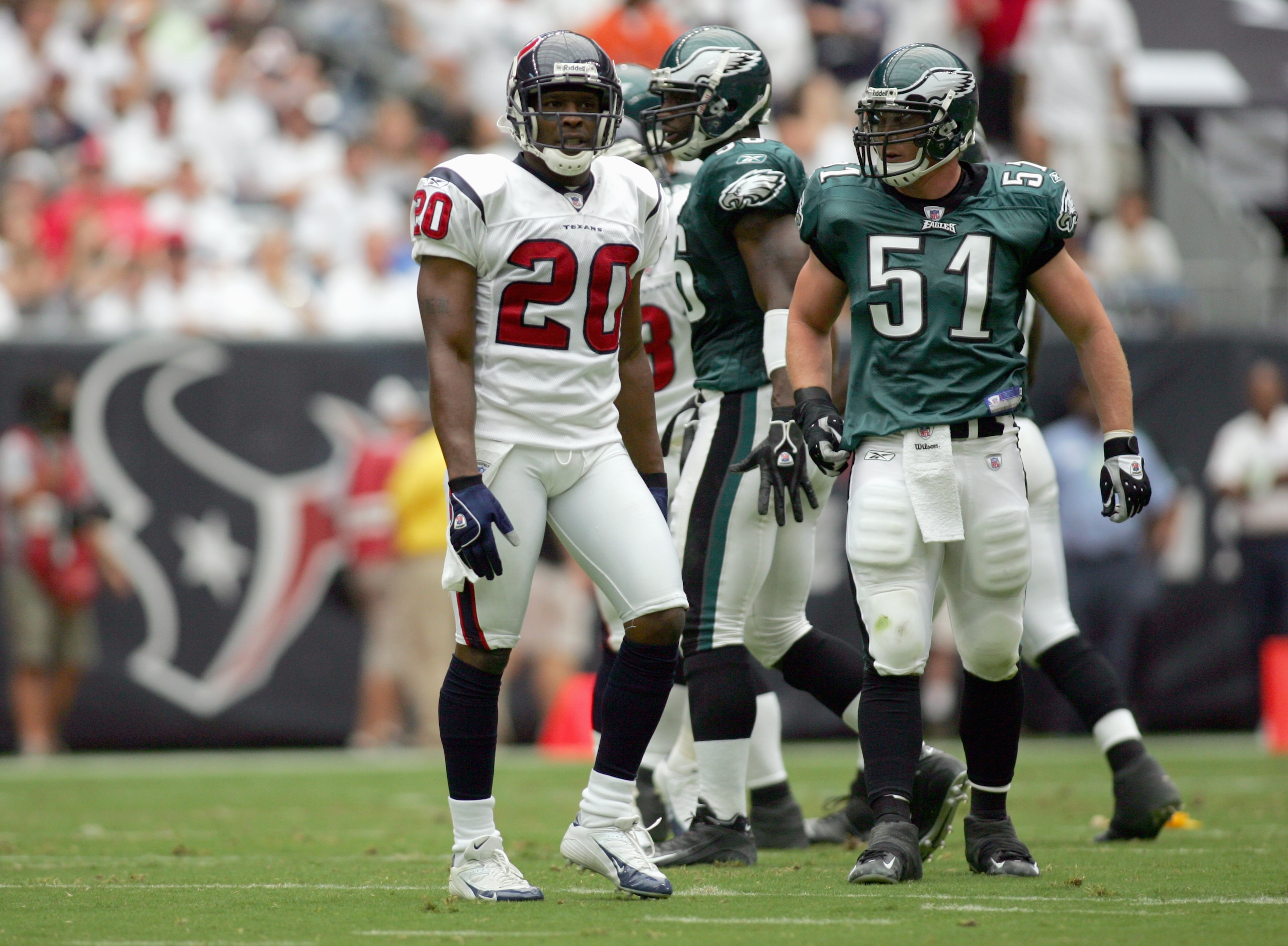 HOUSTON - SEPTEMBER 10: Dexter McCleon #20 of the Houston Texans walks on the field with Matt McCoy #51 of the Philadelphia Eagles on September 10, 2006 at Reliant Stadium in Houston, Texas. (Photo by Ronald Martinez/Getty Images) HOUSTON - SEPTEMBER 10: Dexter McCleon #20 of the Houston Texans walks on the field with Matt McCoy #51 of the Philadelphia Eagles on September 10, 2006 at Reliant Stadium in Houston, Texas. (Photo by Ronald Martinez/Getty Images)