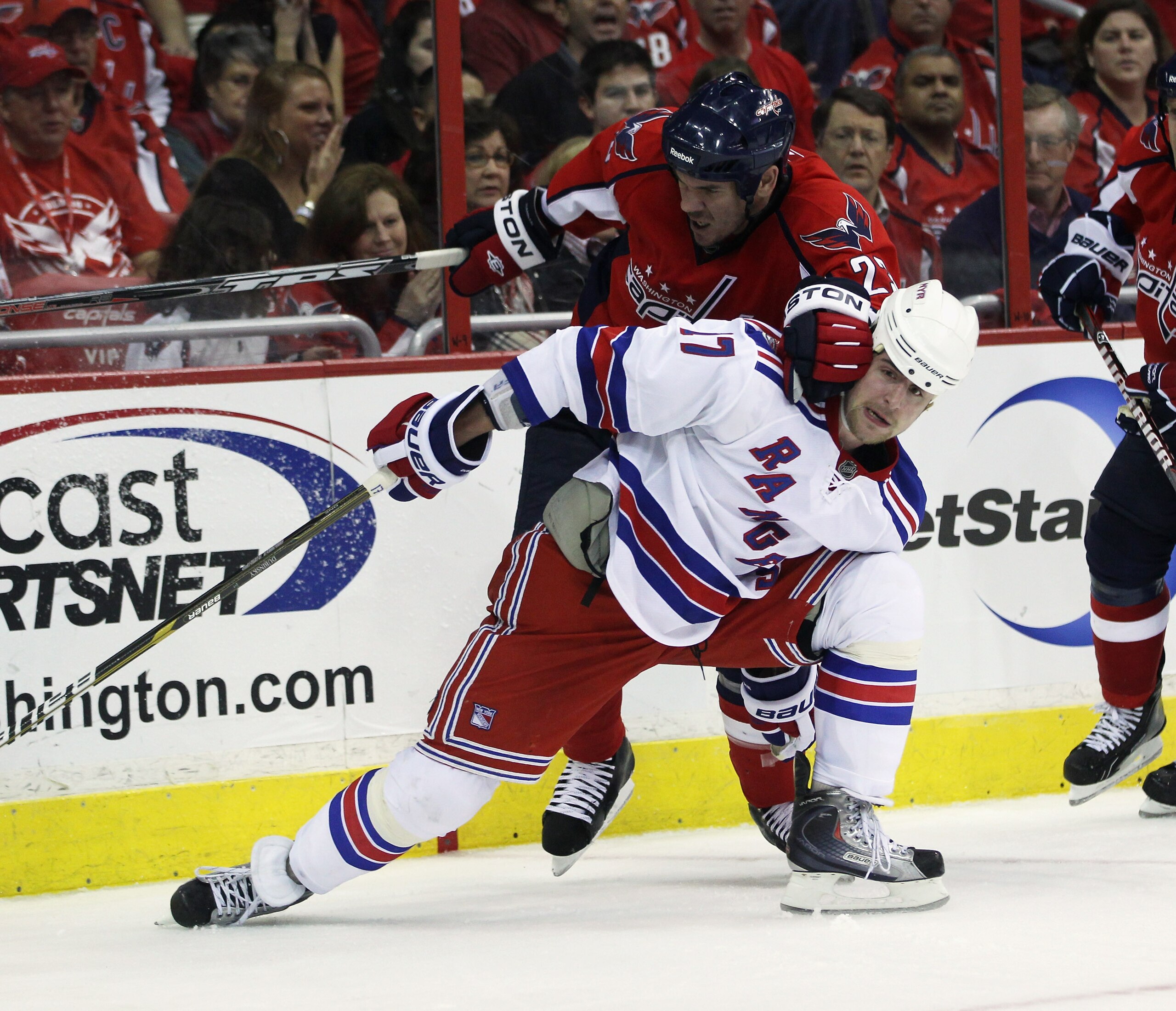 WASHINGTON, DC - APRIL 13:  Scott Hannan #23 of the Washington Capitals hits Brandon Dubinsky #17 of the New York Rangers in Game One of the Eastern Conference Quarterfinals during the 2011 NHL Stanley Cup Playoffs at Verizon Center on April 13, 2011 in W