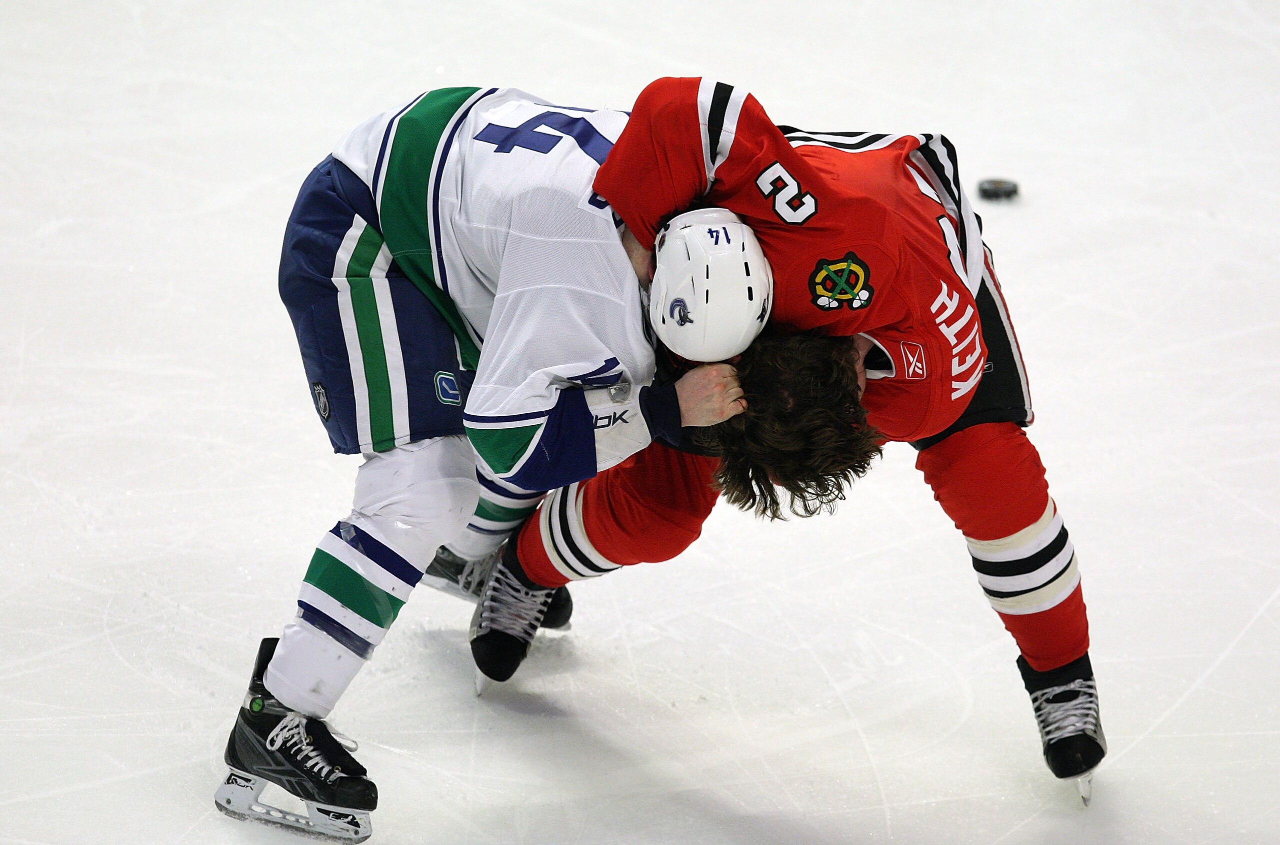 CHICAGO - MARCH 29: Duncan Keith #2 of the Chicago Blackhawks and Alex Burrows #14 of the Vancouver Canucks fight in the third period on March 29, 2009 at the United Center in Chicago, Illinois. The Canucks defeated the Blackhawks 4-0. (Photo by Jonathan