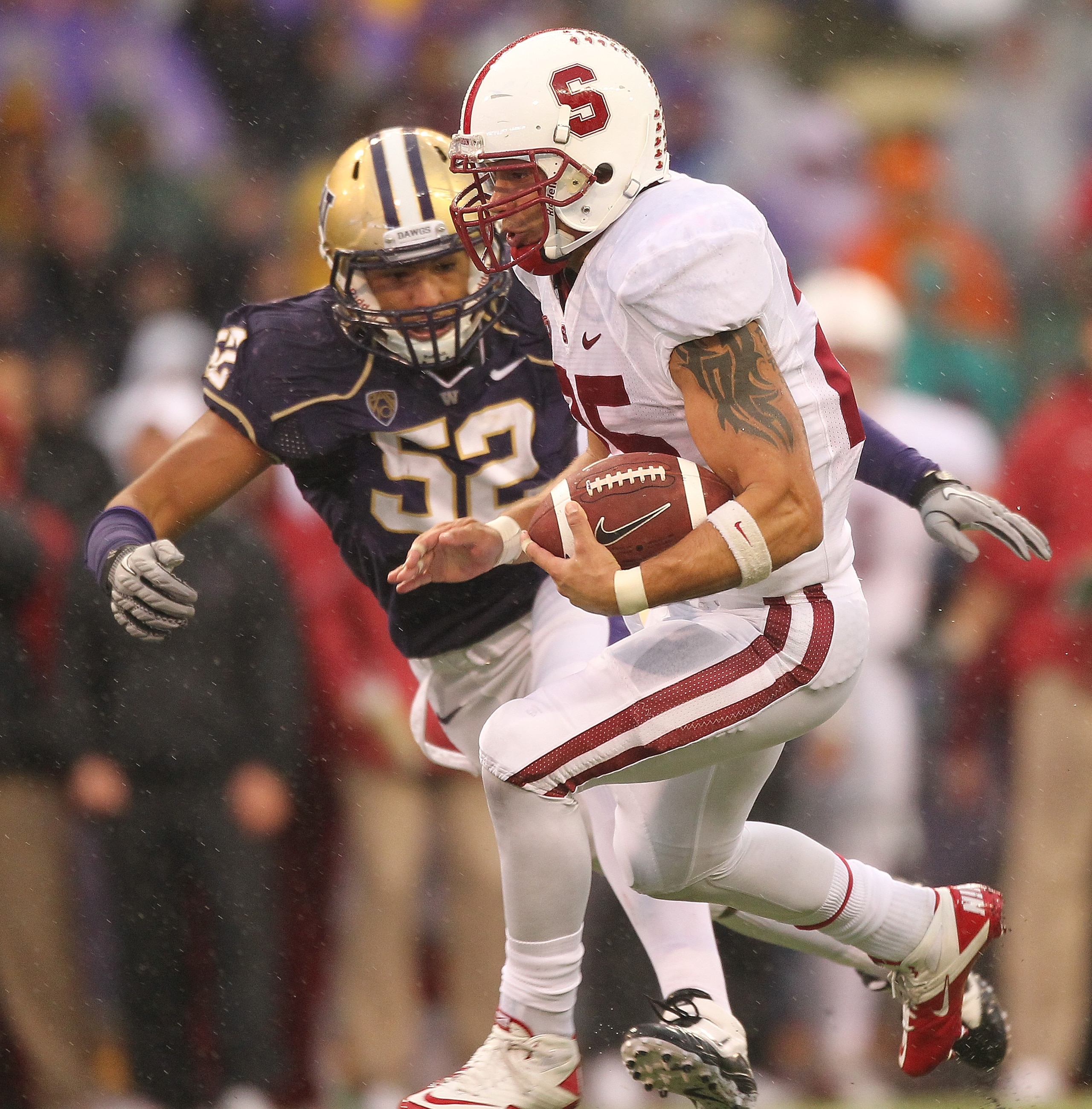 SEATTLE - OCTOBER 30:  Running back Tyler Gaffney #25 of the Stanford Cardinal rushes against Hau'oli Jamora #52 of  the Washington Huskies on October 30, 2010 at Husky Stadium in Seattle, Washington. Stanford defeated Washington 41-0. (Photo by Otto Greu