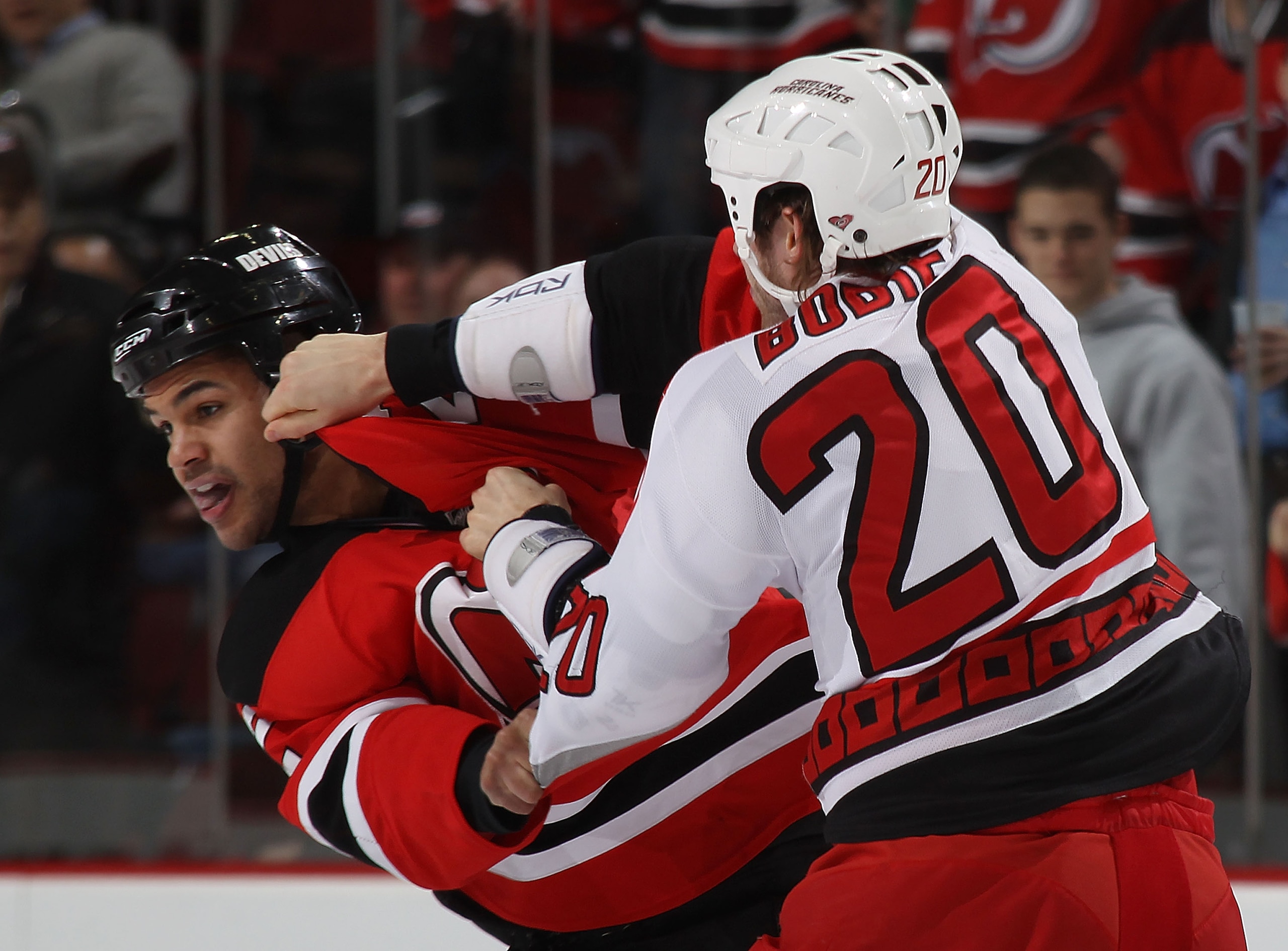 NEWARK, NJ - FEBRUARY 16: Troy Bodie #20 of the Carolina Hurricanes and Mark Fraser #2 of the New Jersey Devils fight during the first period at the Prudential Center on February 16, 2011 in Newark, New Jersey.  (Photo by Bruce Bennett/Getty Images)