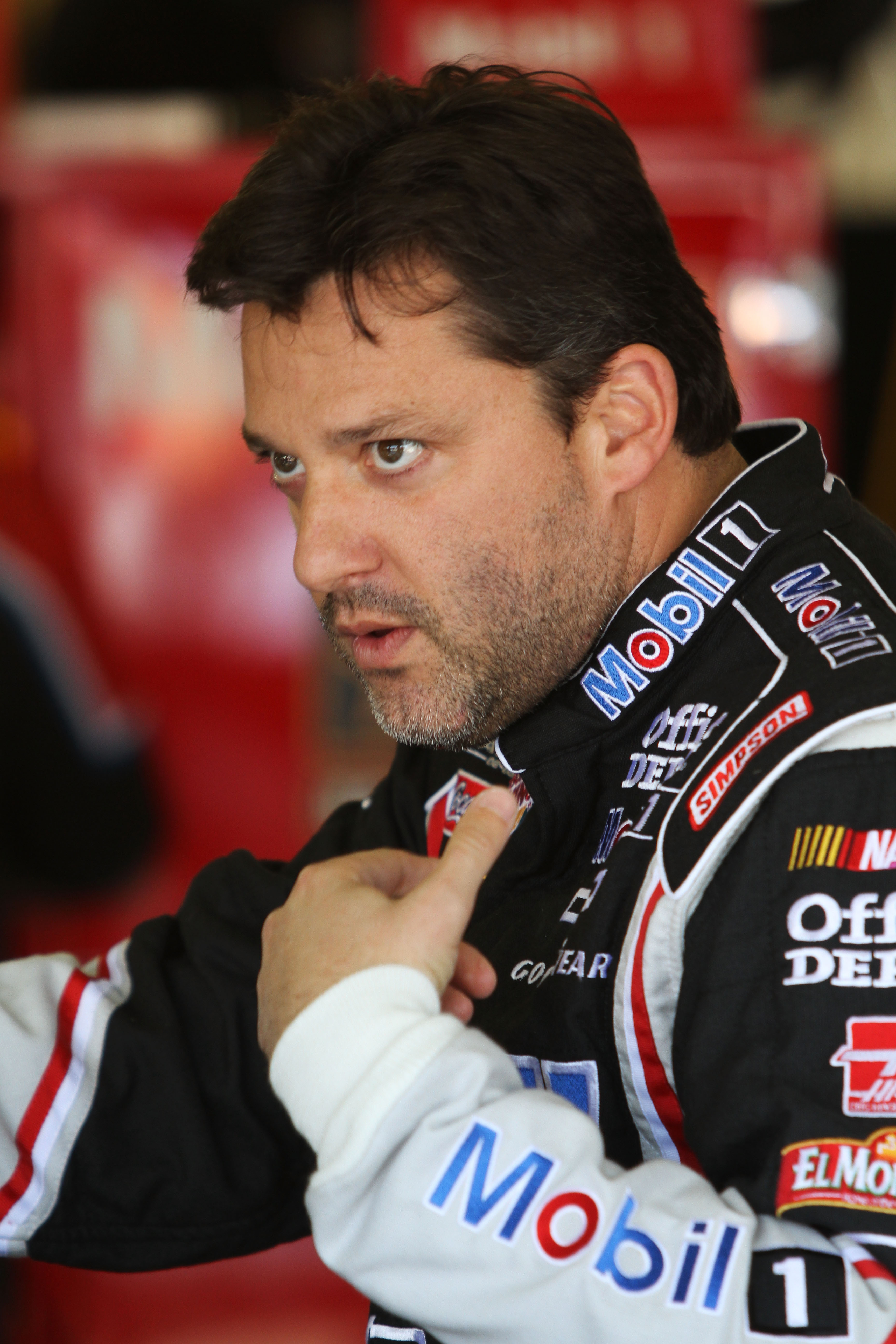 FORT WORTH, TX - APRIL 07:  Tony Stewart, driver of the #14 Mobil 1/Office Depot Chevrolet, stands in the garage during practice for the NASCAR Sprint Cup Series Samsung Mobile 500 at Texas Motor Speedway on April 7, 2011 in Fort Worth, Texas.  (Photo by
