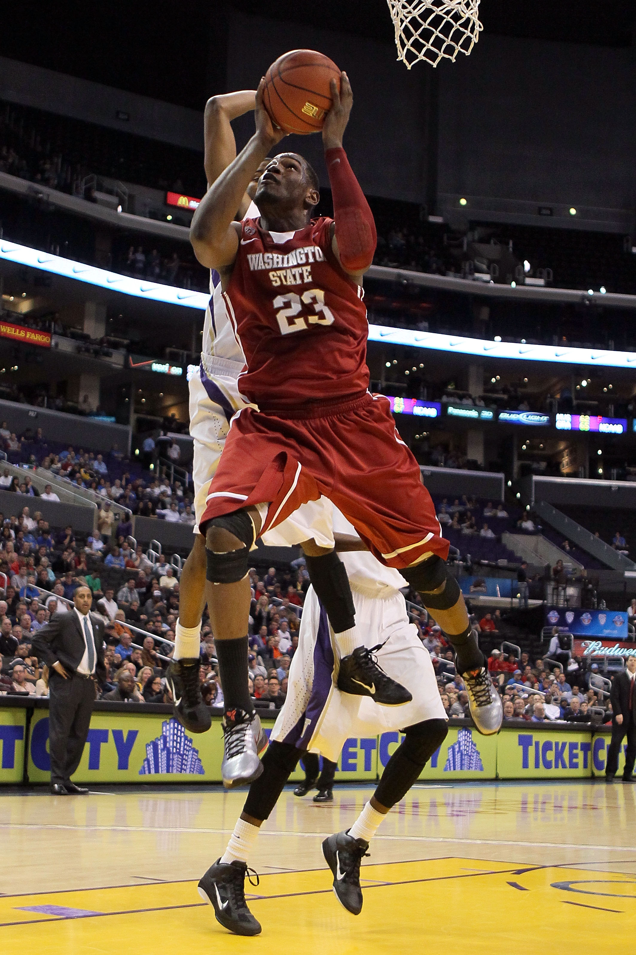 LOS ANGELES, CA - MARCH 10: DeAngelo Casto #23 of the Washington State Cougars goes up for a shot in the lane against the Washington Huskies in the quarterfinals of the 2011 Pacific Life Pac-10 Men's Basketball Tournament at Staples Center on March 10, 2
