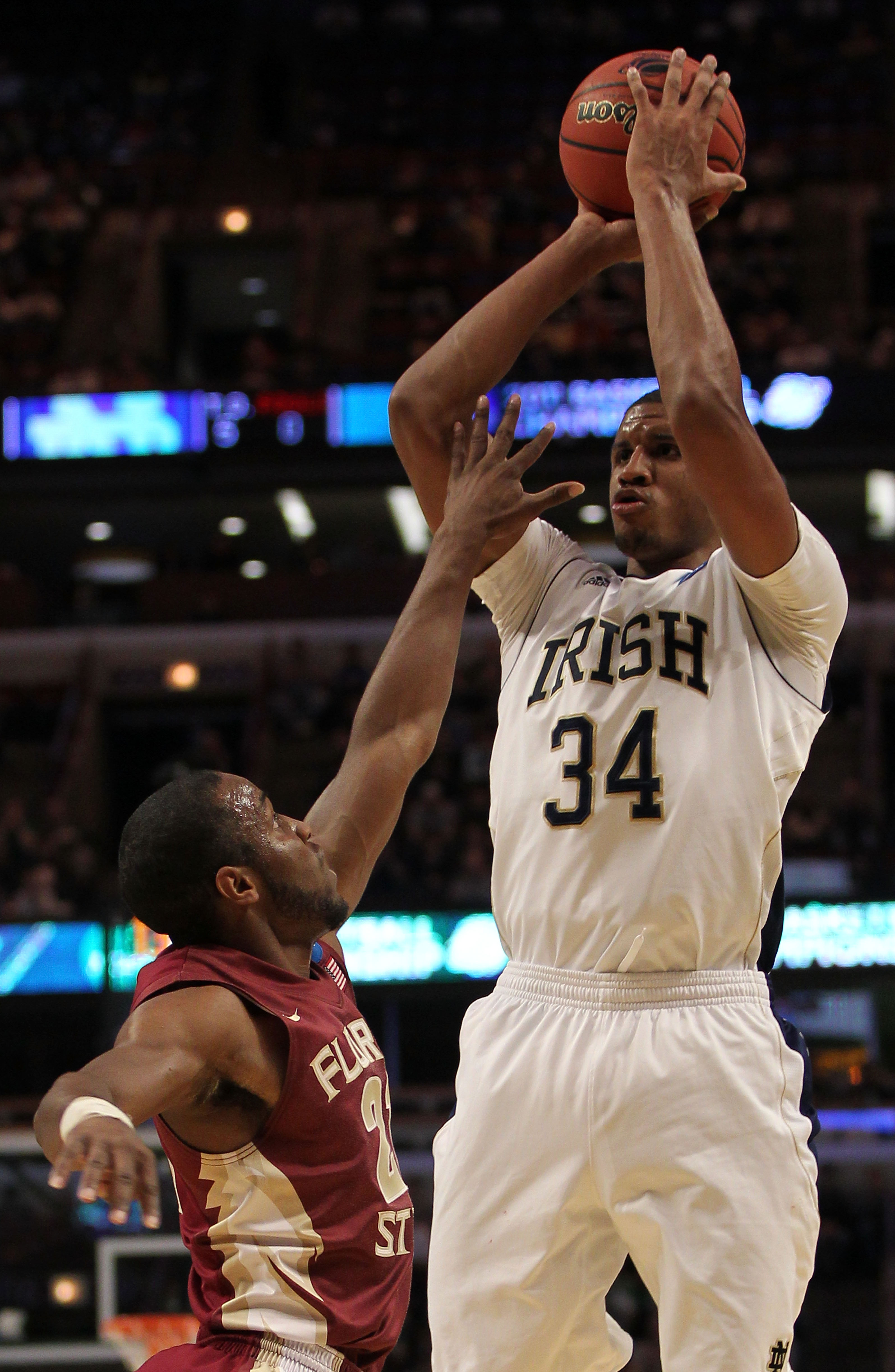 CHICAGO, IL - MARCH 20: Carleton Scott #34 of the Notre Dame Fighting Irish shoots against Michael Snaer #21 of the Florida State Seminoles in the first half during the third round of the 2011 NCAA men's basketball tournament at the United Center on Marc