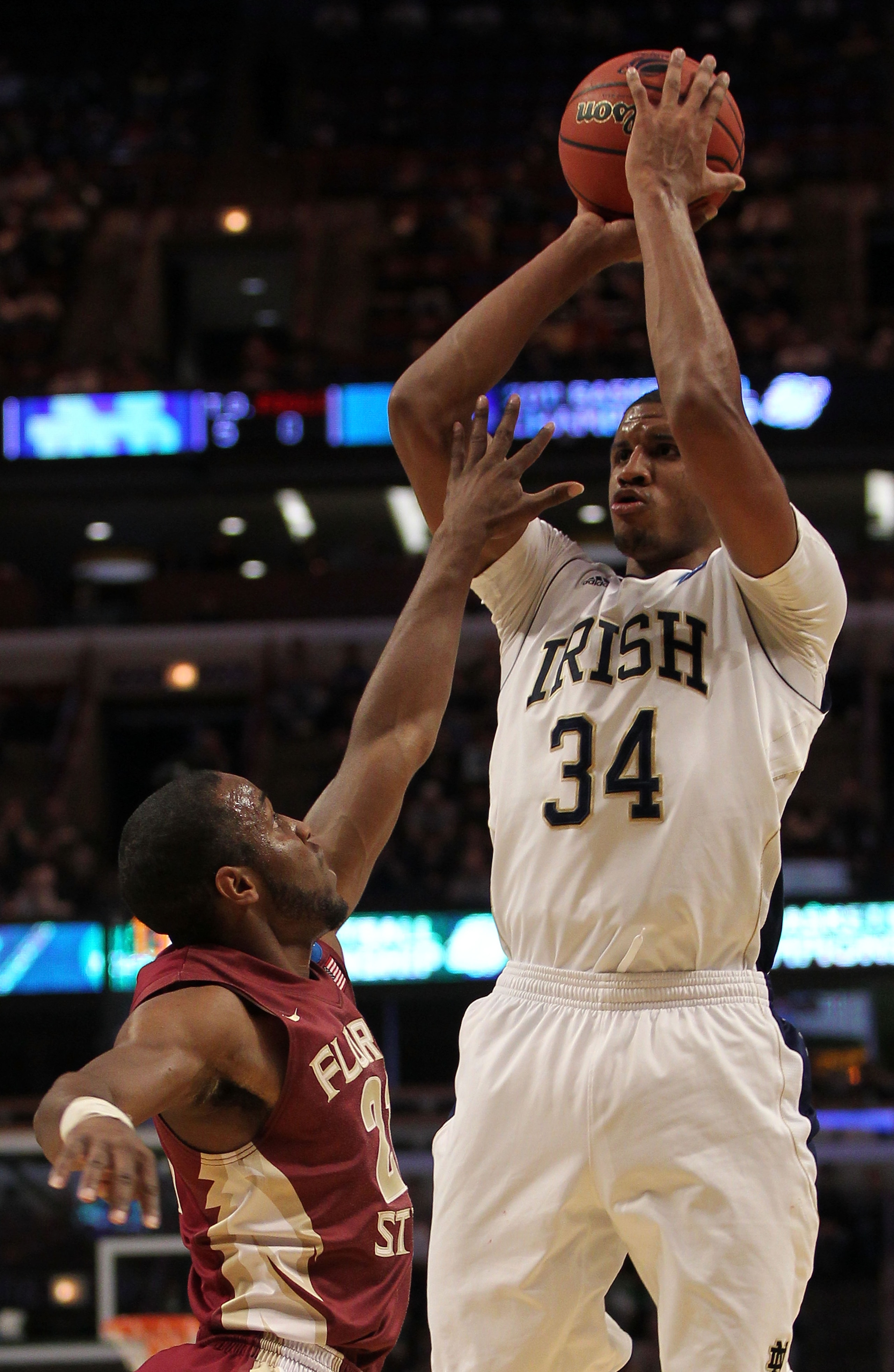 CHICAGO, IL - MARCH 20:  Carleton Scott #34 of the Notre Dame Fighting Irish shoots against Michael Snaer #21 of the Florida State Seminoles in the first half during the third round of the 2011 NCAA men's basketball tournament at the United Center on Marc