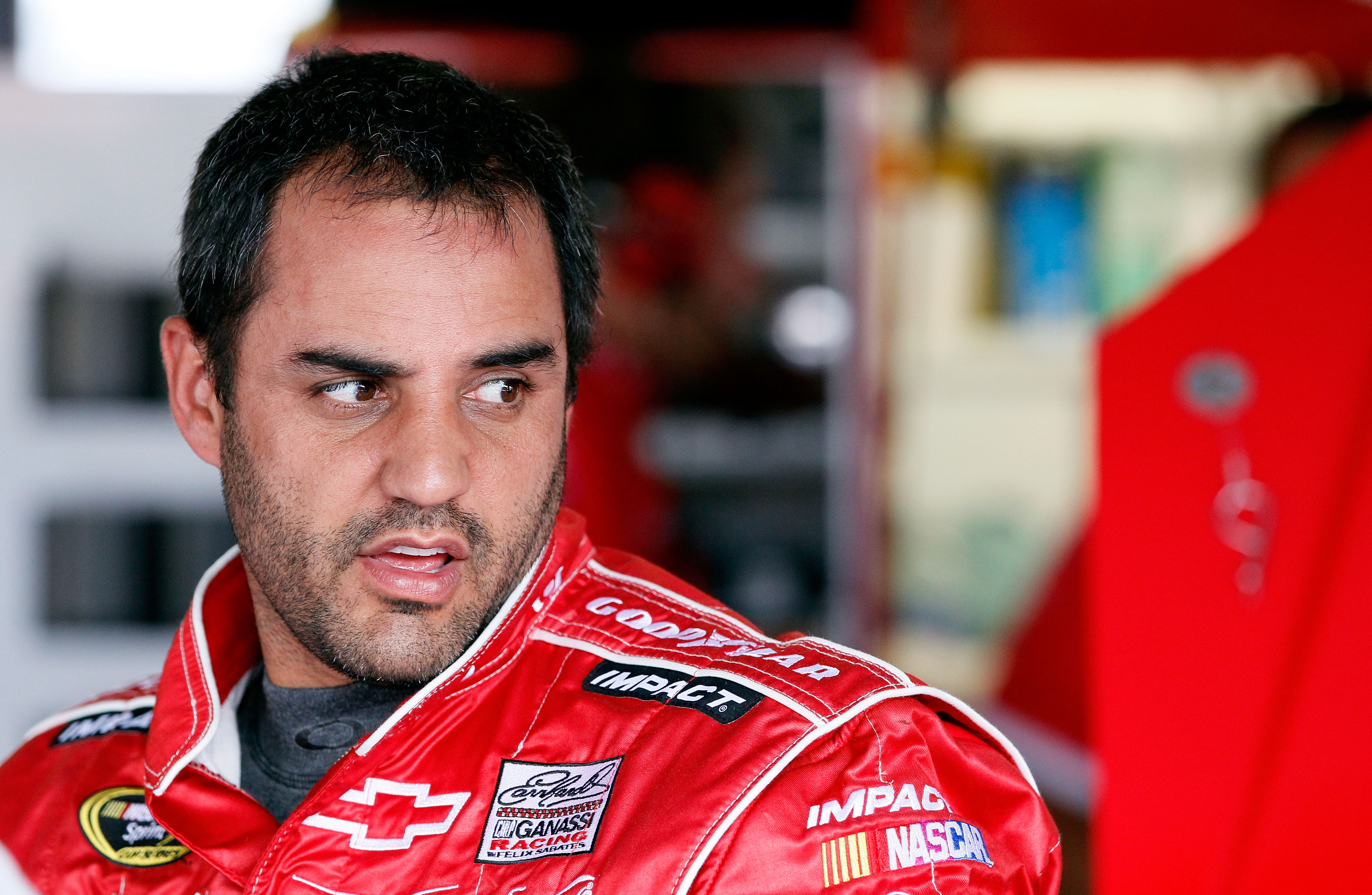 TALLADEGA, AL - APRIL 15:  Juan Pablo Montoya, driver of the #42 Target Chevrolet, stands in the garage during practice for the NASCAR Sprint Cup Series Aaron's 499 at Talladega Superspeedway on April 15, 2011 in Talladega, Alabama.  (Photo by Kevin C. Co