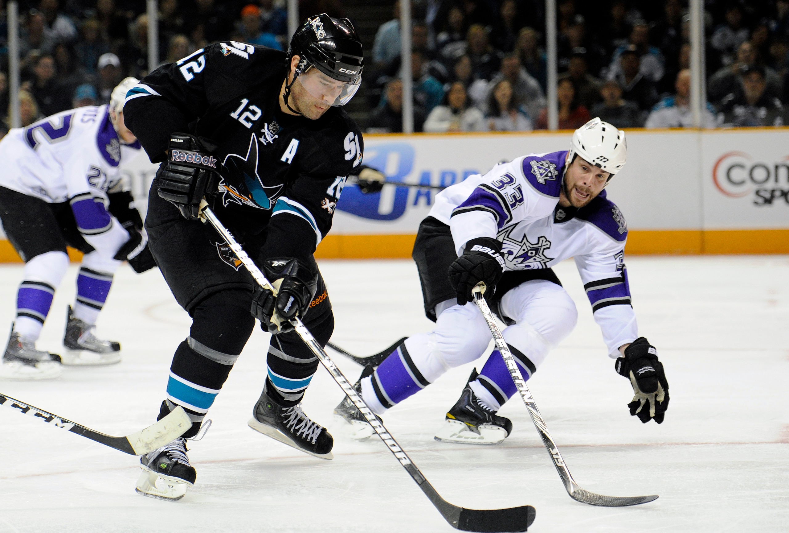 SAN JOSE, CA - APRIL 16: Willie Mitchell #33 of the Los Angeles Kings tries to slow down Patrick Marleau #12 of the San Jose Sharks in Game Two of the Western Conference Quarterfinals during the 2011 NHL Stanley Cup Playoffs at the HP Pavilion on April 16