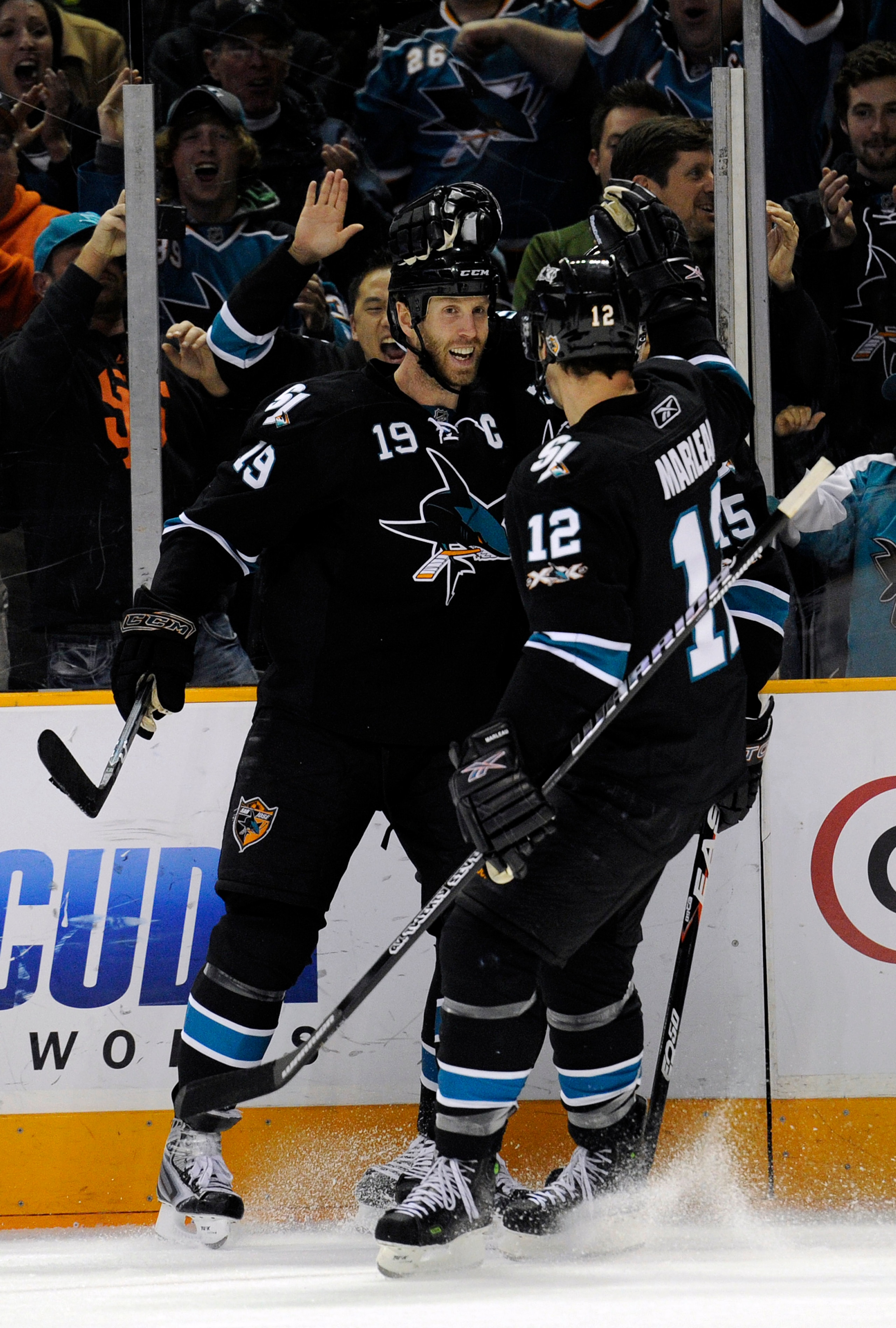 SAN JOSE, CA - DECEMBER 23: Joe Thornton #19 of the San Jose Sharks after scoring a goal celebrates with teammates Patrick Marleau #12 and Dany Heatley #15 against the Phoenix Coyotes during an NHL hockey game at the HP Pavilion on December 23, 2010 in Sa