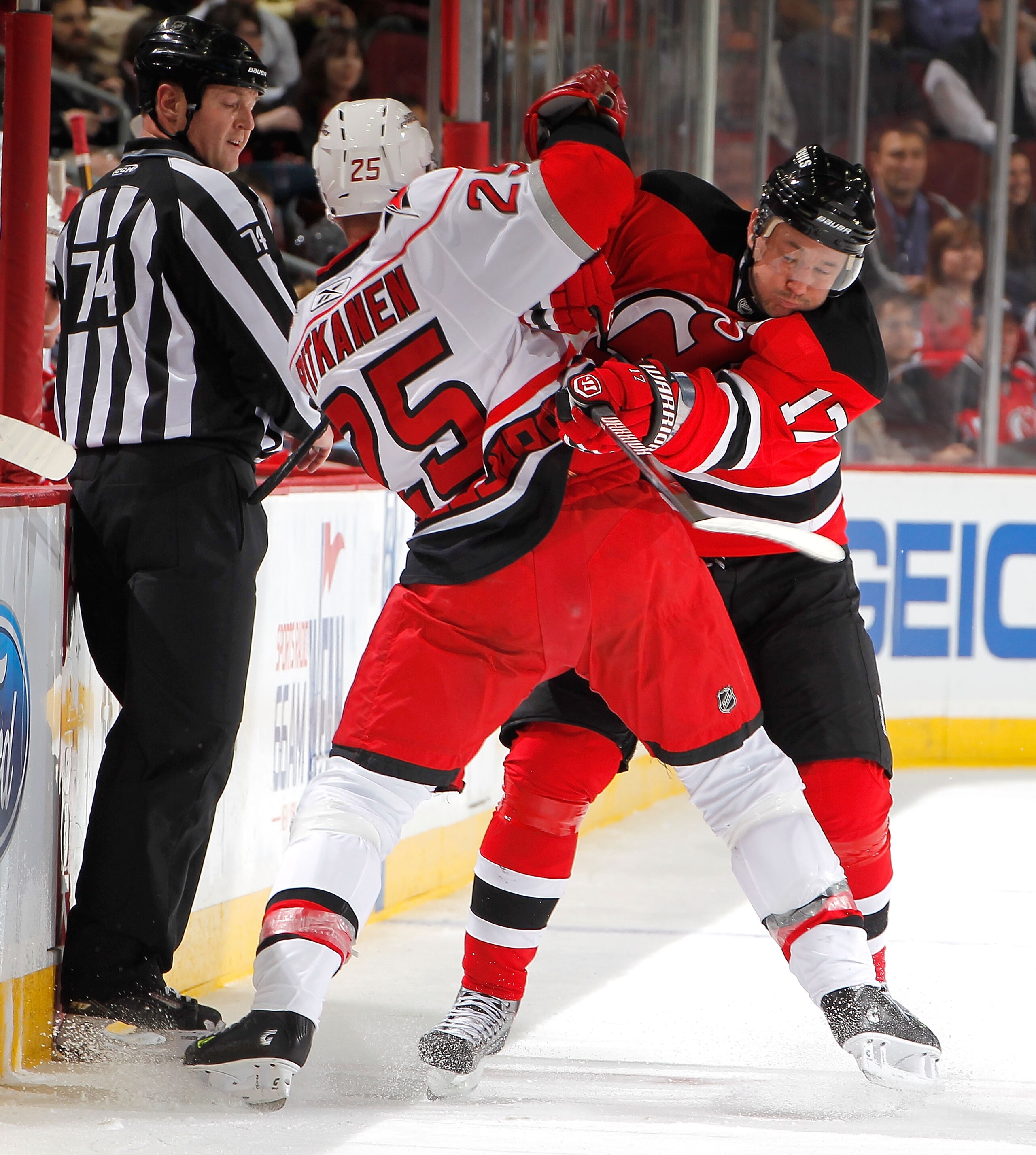 NEWARK, NJ - FEBRUARY 08:  Joni Pitkanen #25 of the Carolina Hurricanes is checked by Ilya Kovalchuk #17 of the New Jersey Devils during the second period of an NHL hockey game at the Prudential Center on February 8, 2011 in Newark, New Jersey.  (Photo by