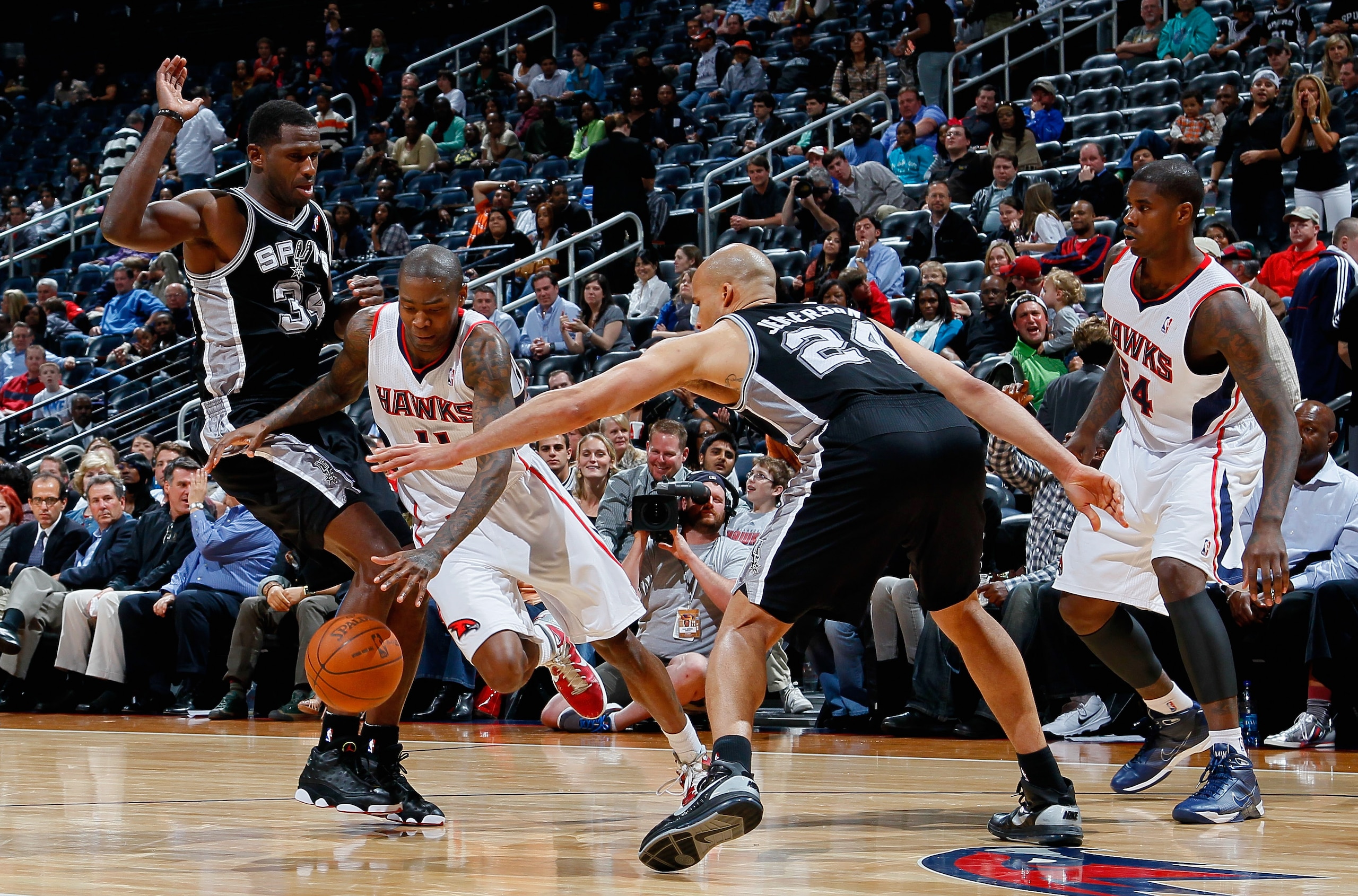 ATLANTA, GA - APRIL 05: Jamal Crawford #11 of the Atlanta Hawks drives between Antonio McDyess #34 and Richard Jefferson #24 of the San Antonio Spurs at Philips Arena on April 5, 2011 in Atlanta, Georgia. NOTE TO USER: User expressly acknowledges and ag ATLANTA, GA - APRIL 05: Jamal Crawford #11 of the Atlanta Hawks drives between Antonio McDyess #34 and Richard Jefferson #24 of the San Antonio Spurs at Philips Arena on April 5, 2011 in Atlanta, Georgia. NOTE TO USER: User expressly acknowledges and ag