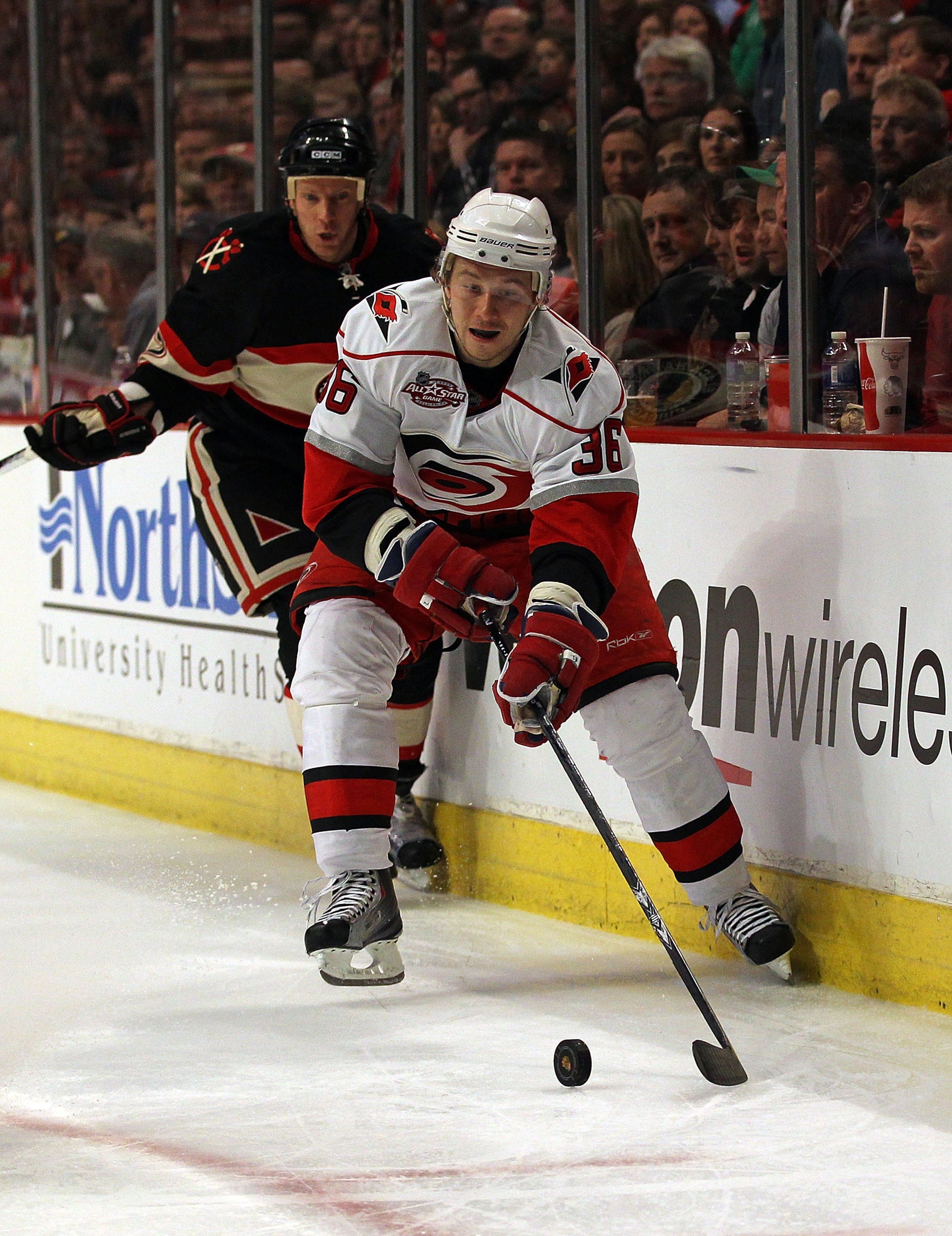 CHICAGO, IL - MARCH 04: Jussi Jokinen #36 of the Carolina Hurricanes controls the puck in front of Ryan Johnson #17 of the Chicago Blackhawks at the United Center on March 4, 2011 in Chicago, Illinois. The Blackhawks defeated the Hurricanes 5-2.  (Photo b