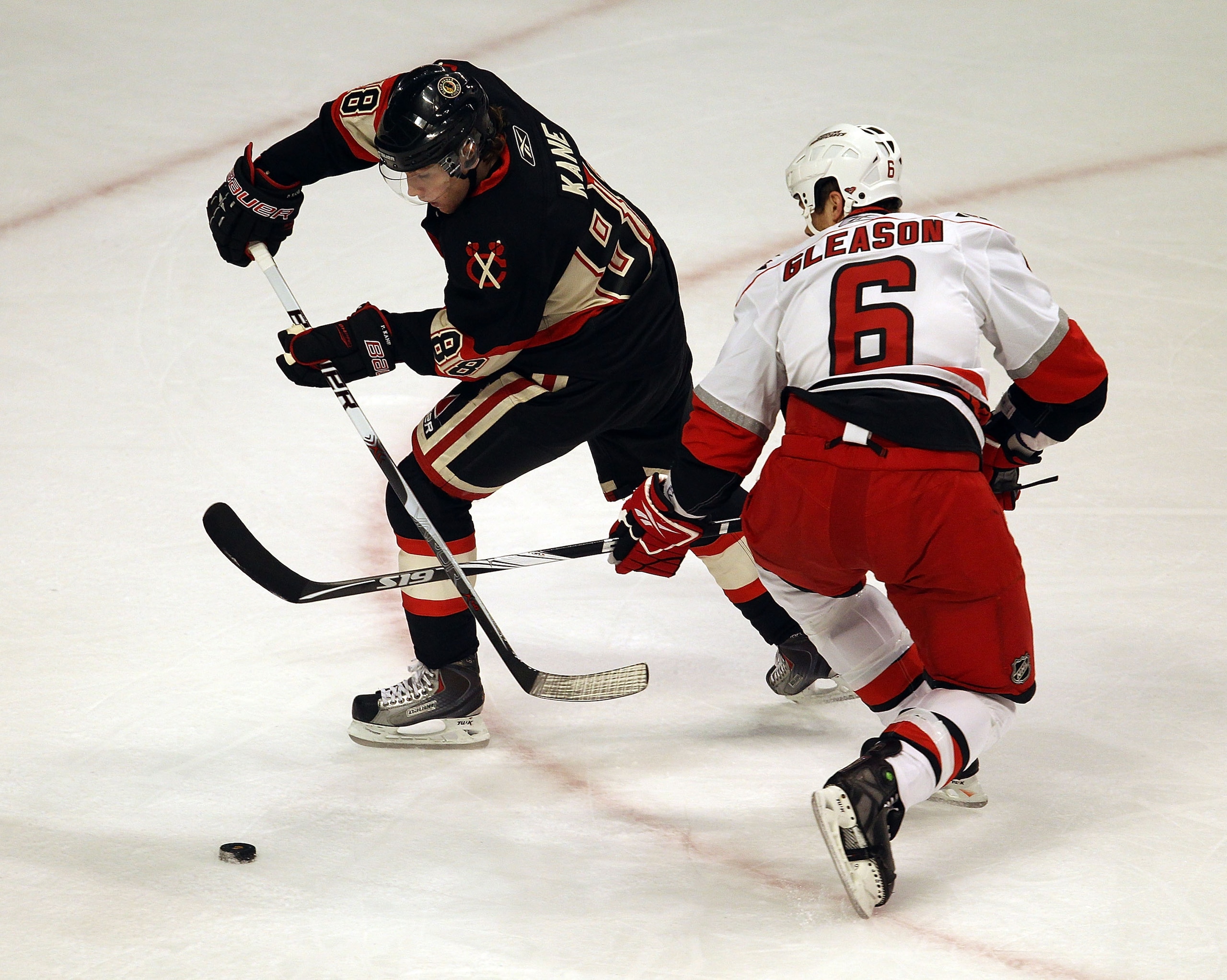 CHICAGO, IL - MARCH 04: Patrick Kane #88 of the Chicago Blackhawks skates around Tim Gleason #6 of the Carolina Hurricanes at the United Center on March 4, 2011 in Chicago, Illinois. (Photo by Jonathan Daniel/Getty Images)