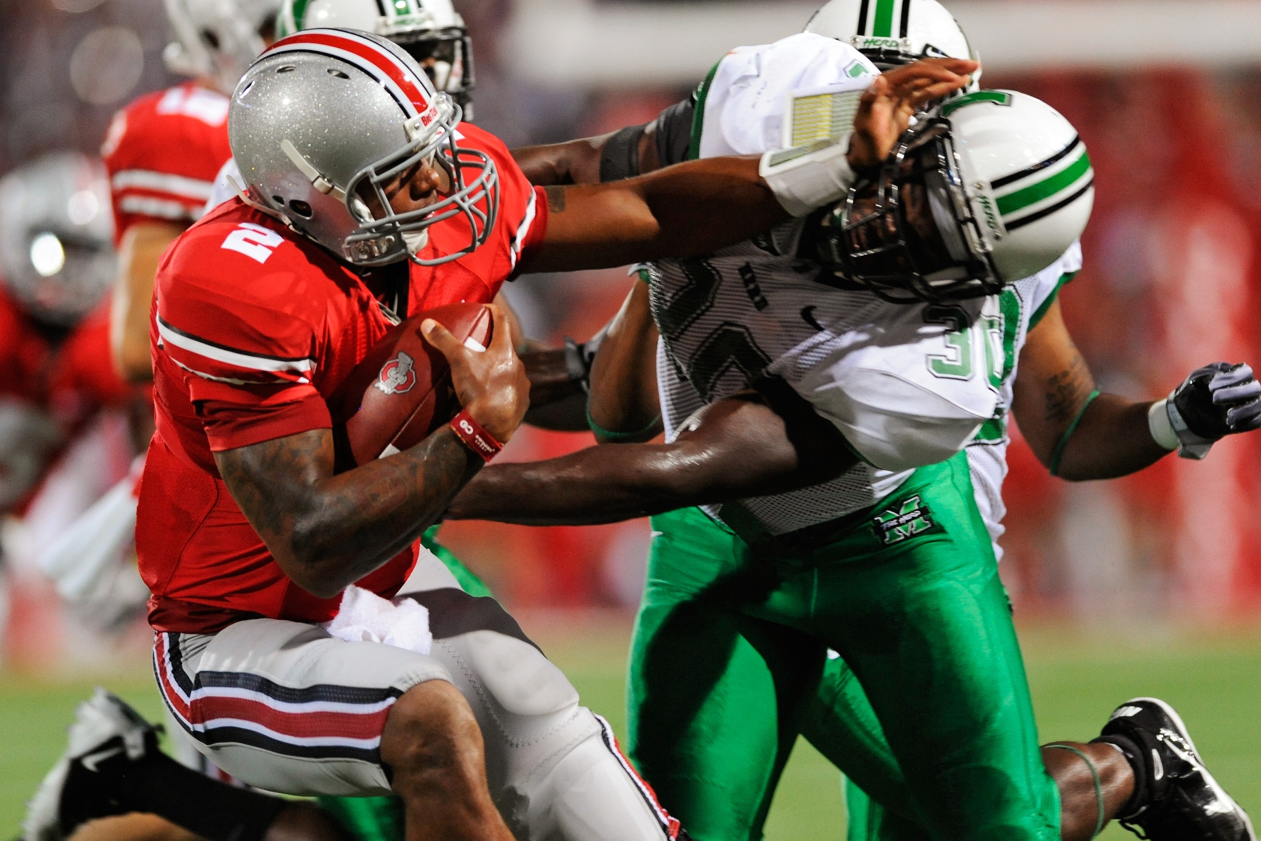 COLUMBUS, OH - SEPTEMBER 2: Terrelle Pryor #2 of the Ohio State Buckeyes stiff arms Mario Harvey #30 of the Marshall Thundering Herd at Ohio Stadium on September 2, 2010 in Columbus, Ohio. (Photo by Jamie Sabau/Getty Images) COLUMBUS, OH - SEPTEMBER 2: Terrelle Pryor #2 of the Ohio State Buckeyes stiff arms Mario Harvey #30 of the Marshall Thundering Herd at Ohio Stadium on September 2, 2010 in Columbus, Ohio. (Photo by Jamie Sabau/Getty Images)