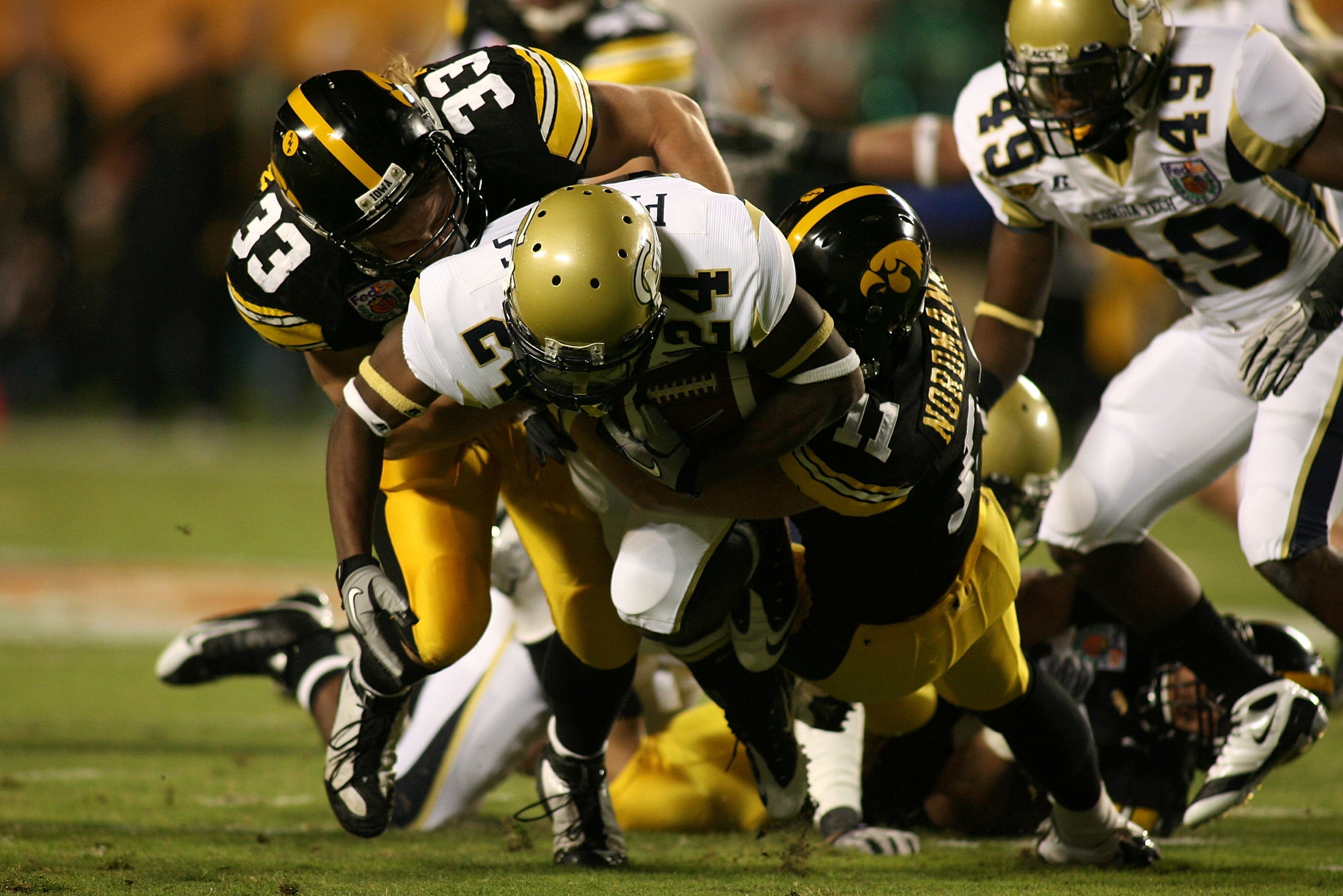 MIAMI GARDENS, FL - JANUARY 05: Embry Peeples of the Georgia Tech Yellow Jackets is bought down by Jeff Tarpinian #33 and Don Nordmann #11 of the Iowa Hawkeyes during the FedEx Orange Bowl at Land Shark Stadium on January 5, 2010 in Miami Gardens, Florid MIAMI GARDENS, FL - JANUARY 05: Embry Peeples of the Georgia Tech Yellow Jackets is bought down by Jeff Tarpinian #33 and Don Nordmann #11 of the Iowa Hawkeyes during the FedEx Orange Bowl at Land Shark Stadium on January 5, 2010 in Miami Gardens, Florid