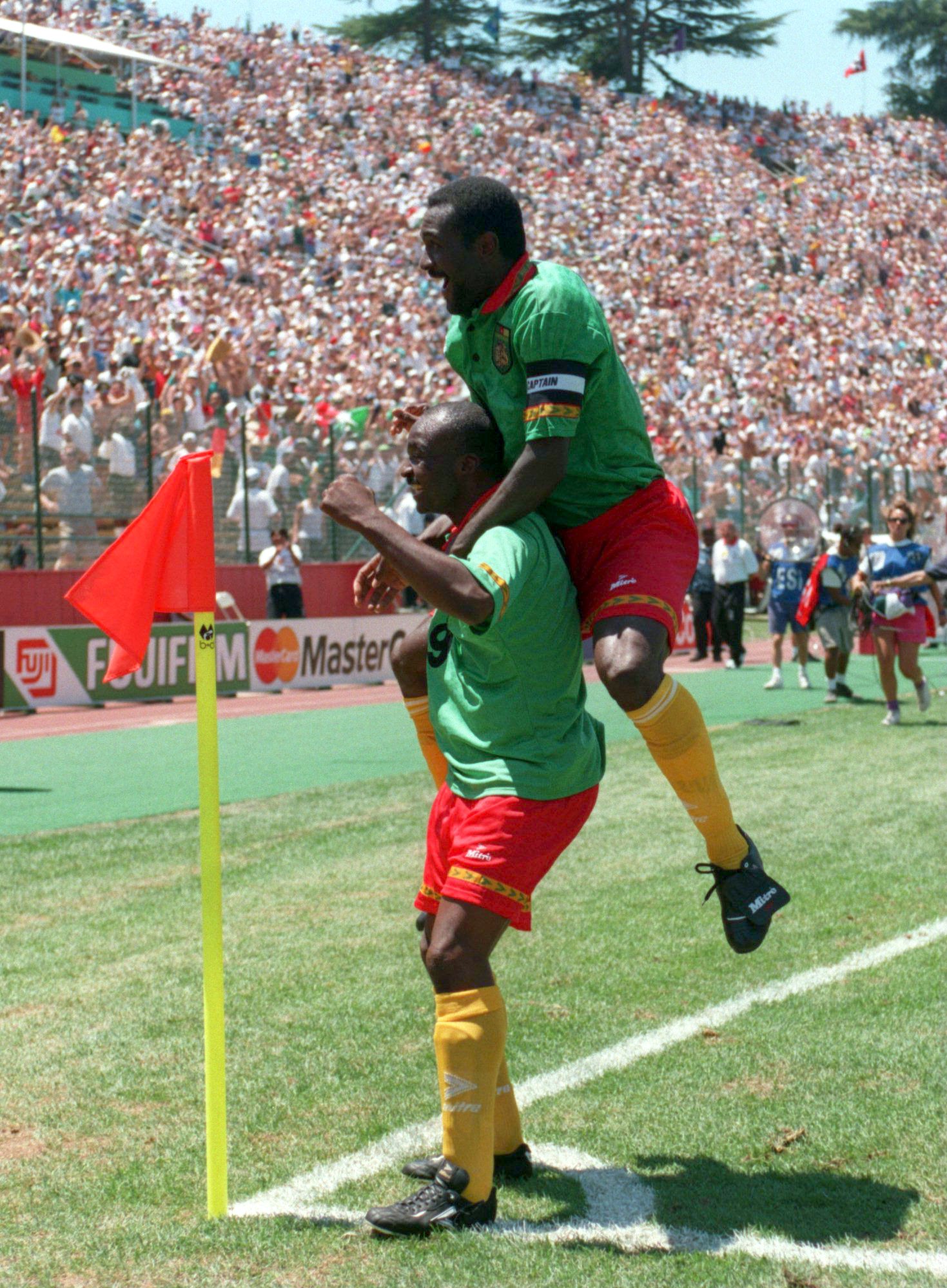 28 JUN 1994:  ROGER MILLA OF CAMEROON CELEBRATES AFTER SCORING CAMEROON's ONLY GOAL AGAINST RUSSIA DURING THEIR 1994 WORLD CUP MATCH AT THE STANFORD STADIUM IN PALO ALTO, CALIFORNIA. Mandatory Credit: Stephen Dunn/ALLSPORT