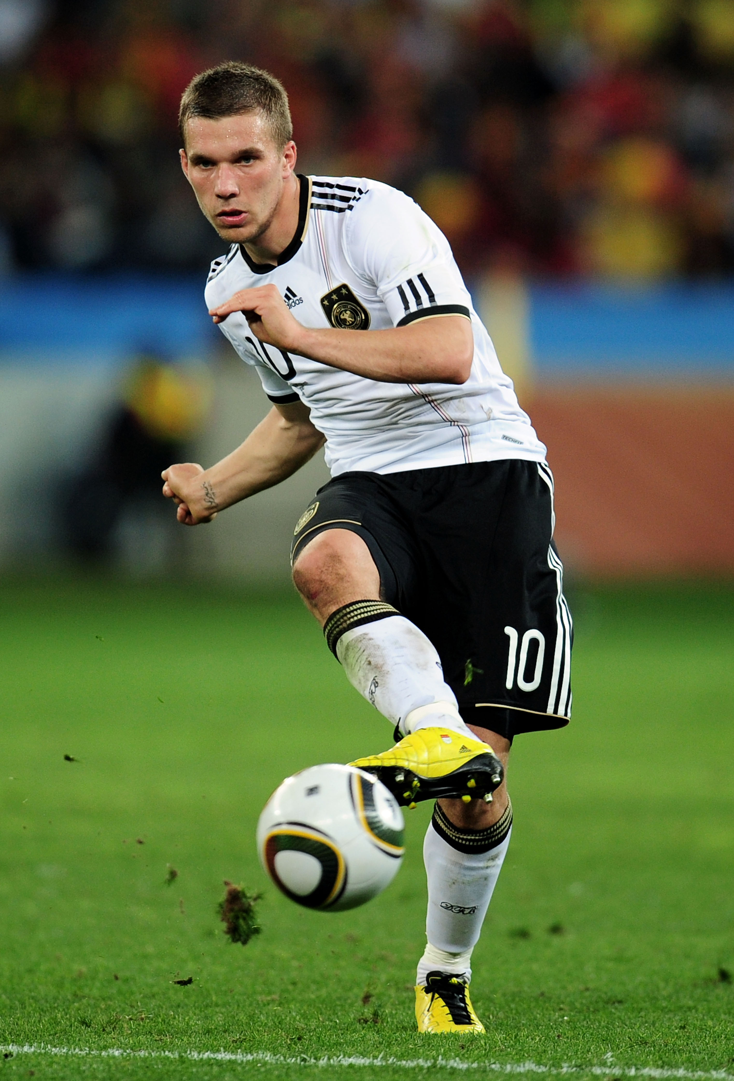 DURBAN, SOUTH AFRICA - JULY 07:  Lukas Podolski of Germany passes the ball during the 2010 FIFA World Cup South Africa Semi Final match between Germany and Spain at Durban Stadium on July 7, 2010 in Durban, South Africa.  (Photo by Clive Mason/Getty Image